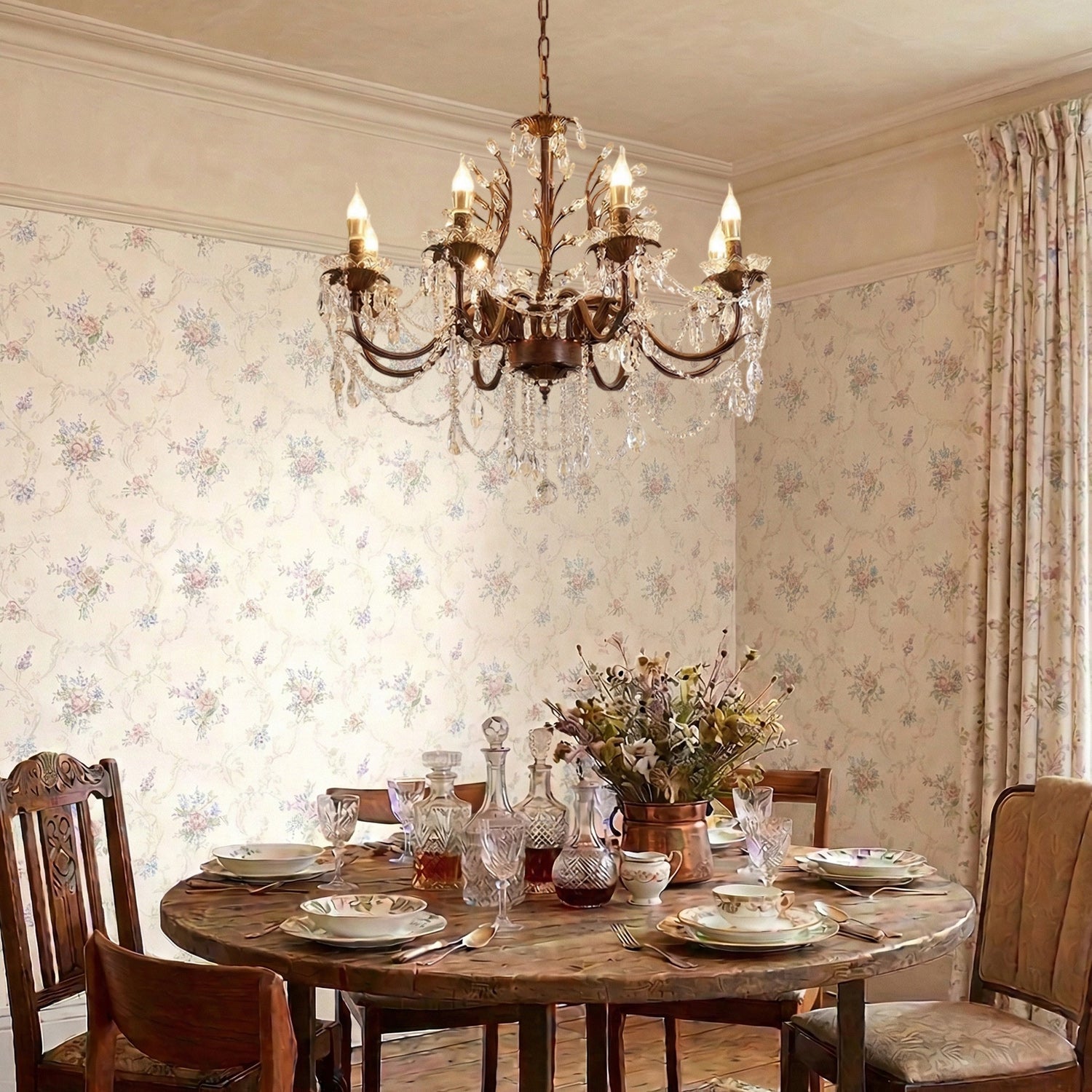 Ariae Chandelier hanging over a dining table in a Mediterranean-inspired interior.