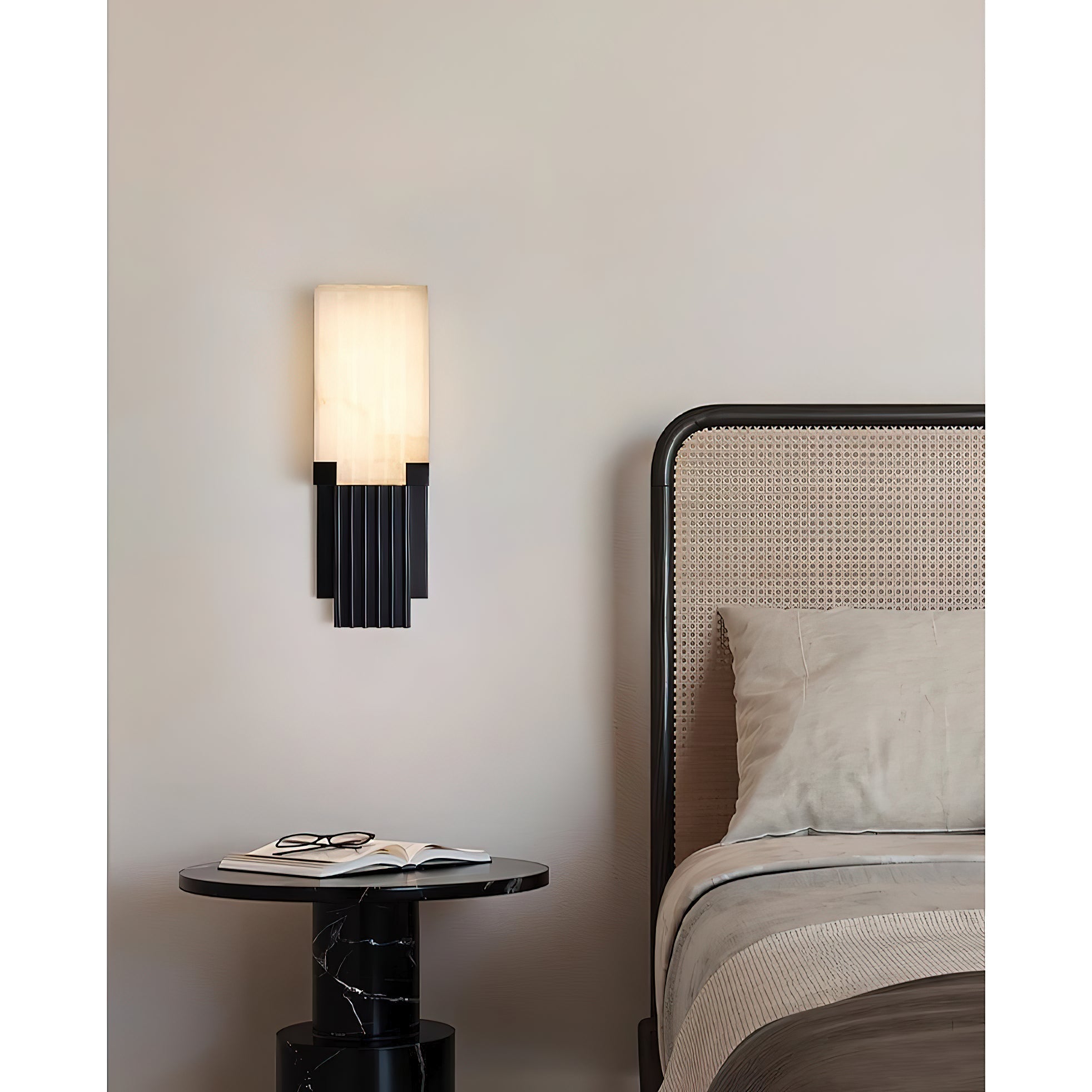 The Ariel Wall Lamp illuminated, casting a warm and inviting glow.