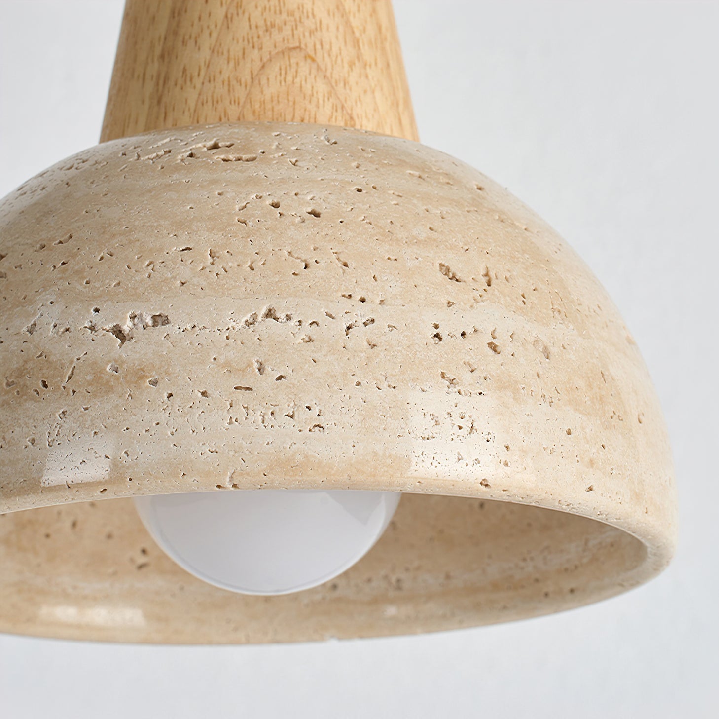 The dome-shaped silhouette of the Arluoe Travertine Pendant Lamp.
