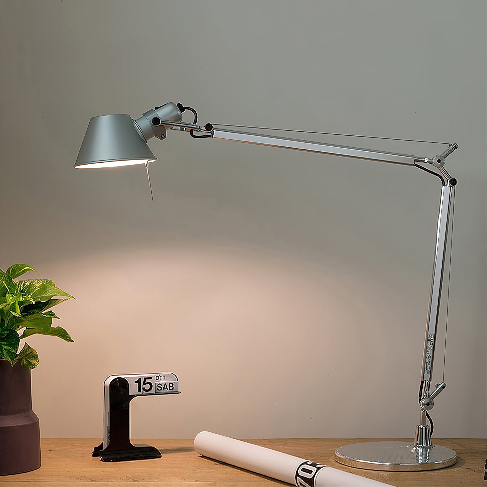 The weighted aluminum base of the desk lamp, providing stability.