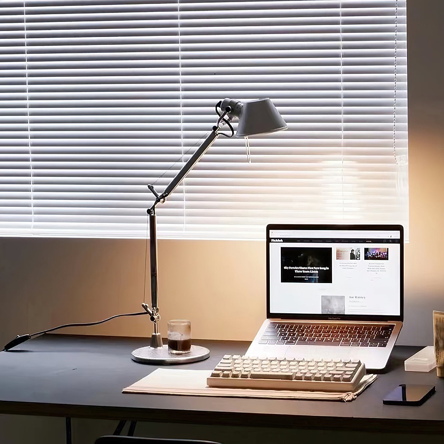 The table lamp used as a reading light next to an armchair.