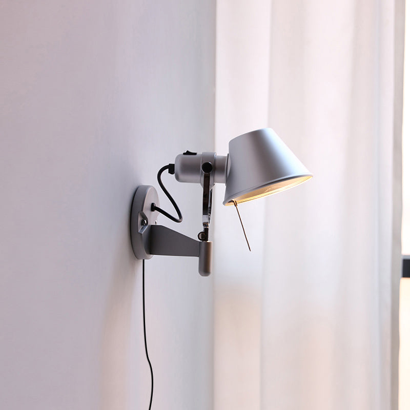 Sconce shown in a living room setting next to a sofa.