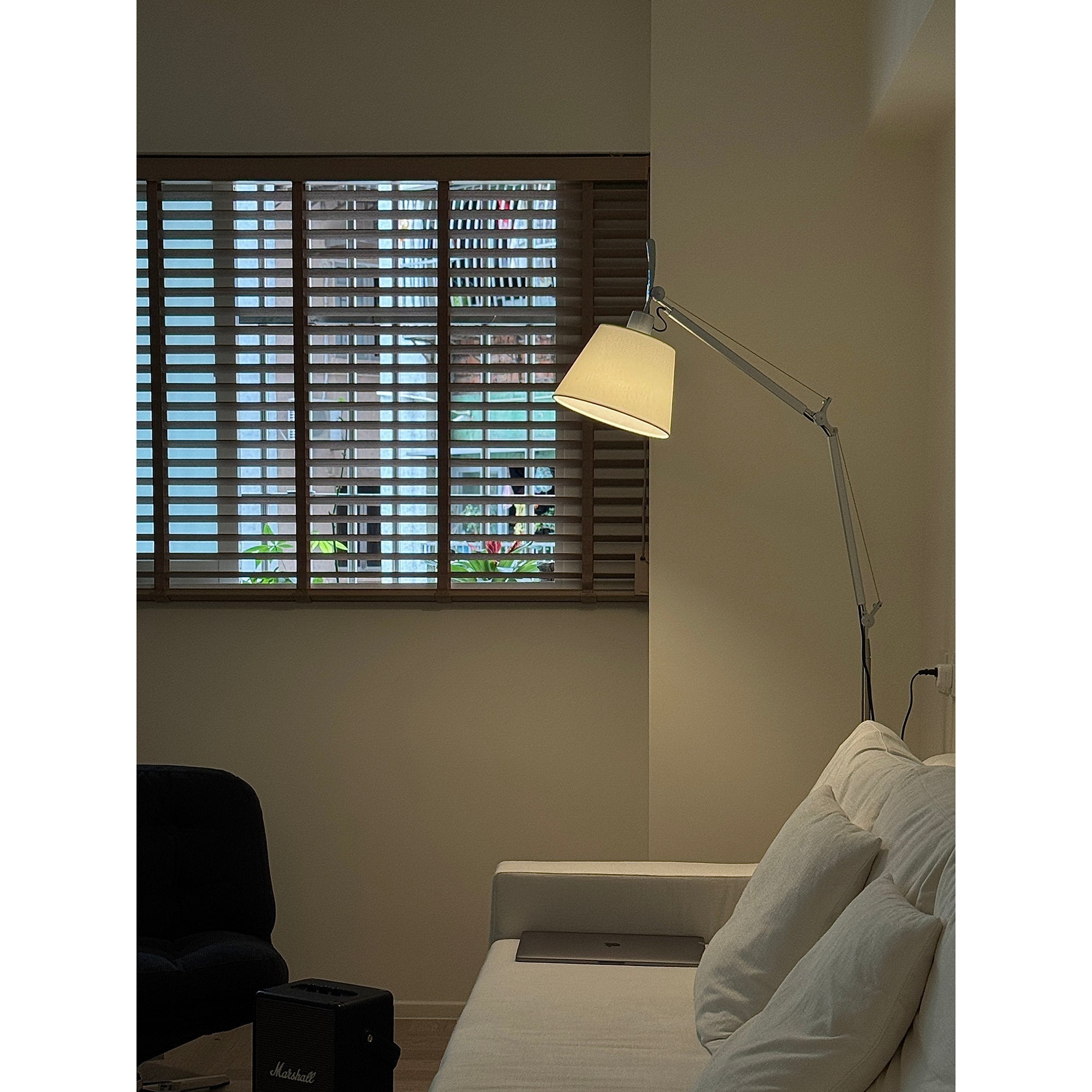 Costanza Floor Lamp next to a sofa.