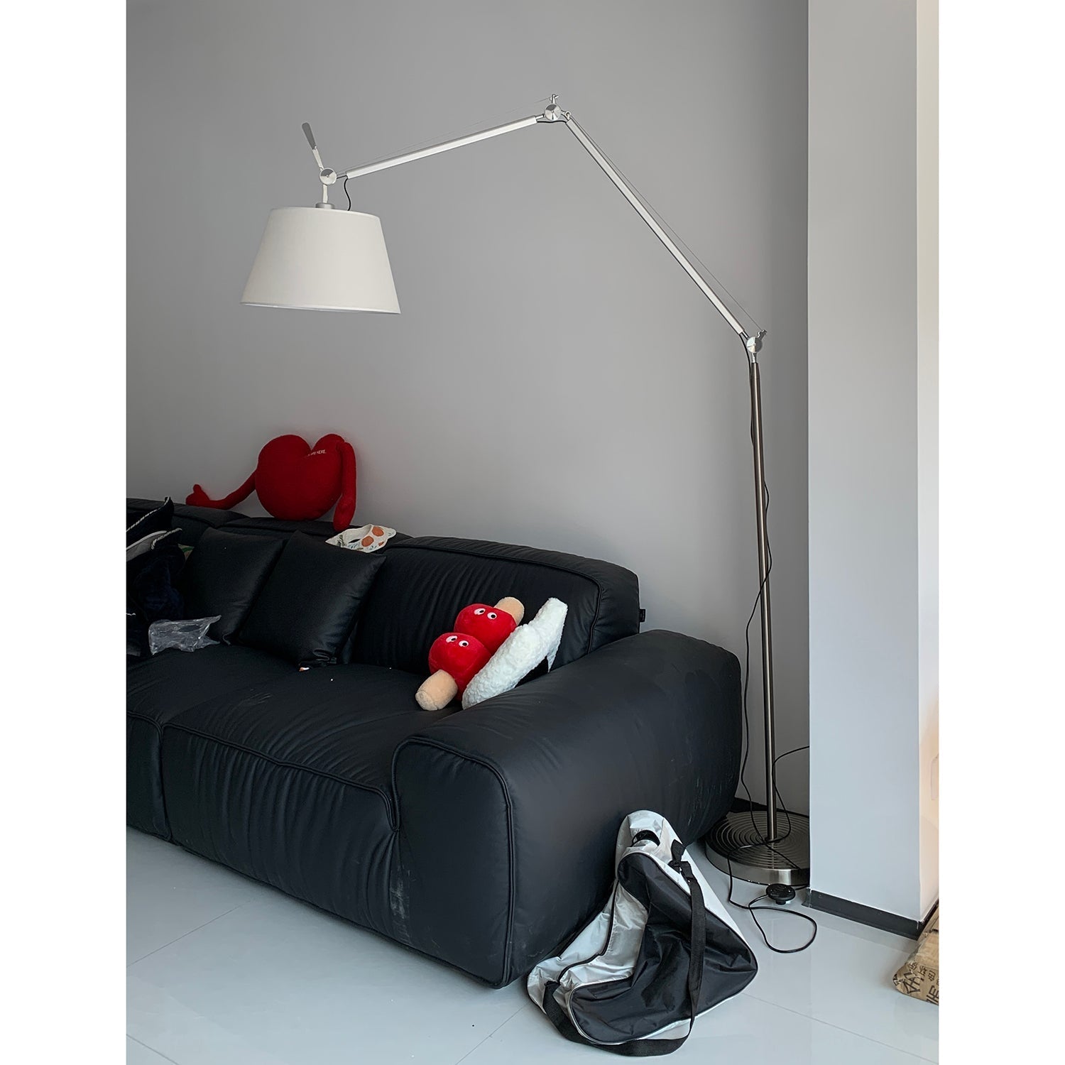 The silver lamp body with a white shade.