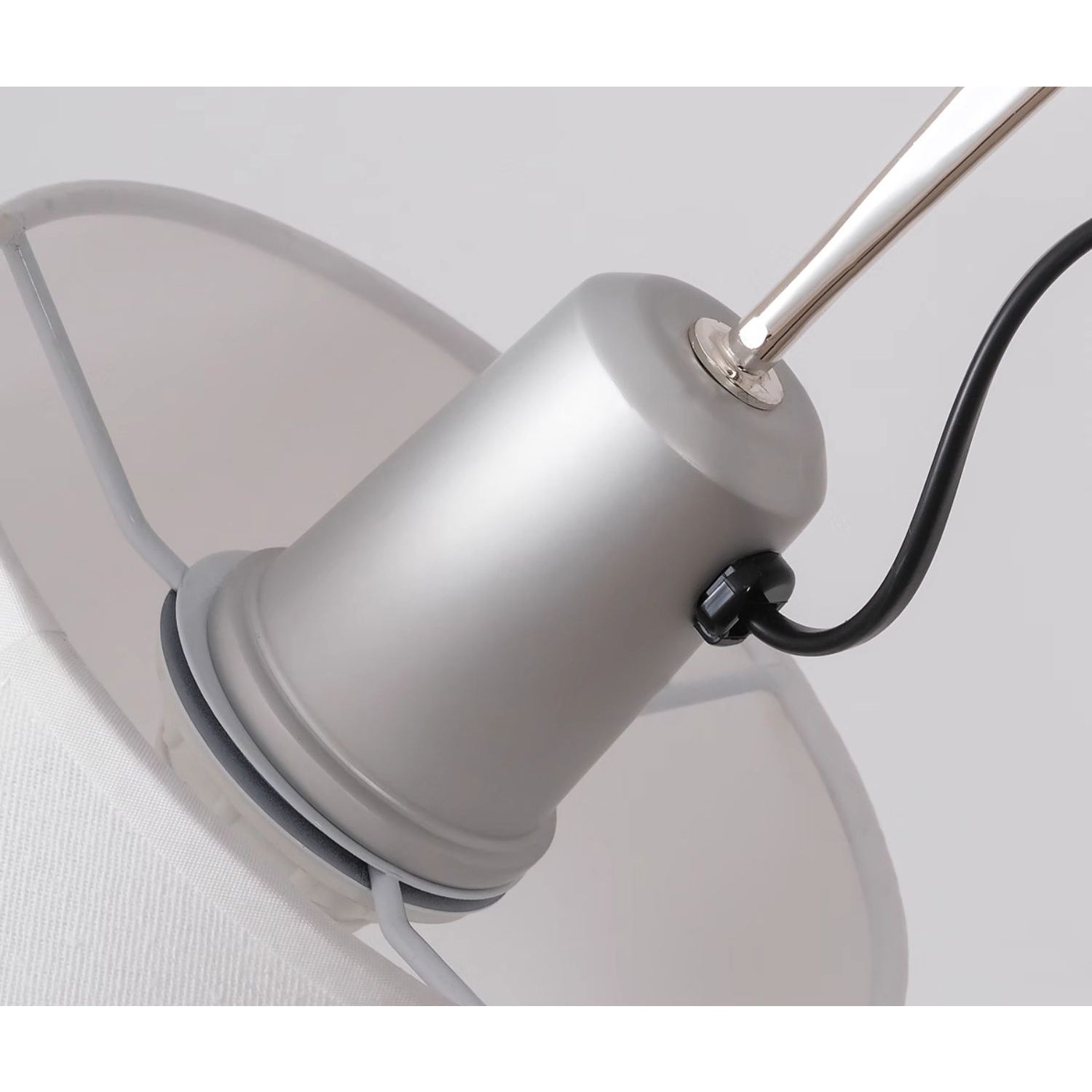 The silver Costanza lamp reflecting ambient light.