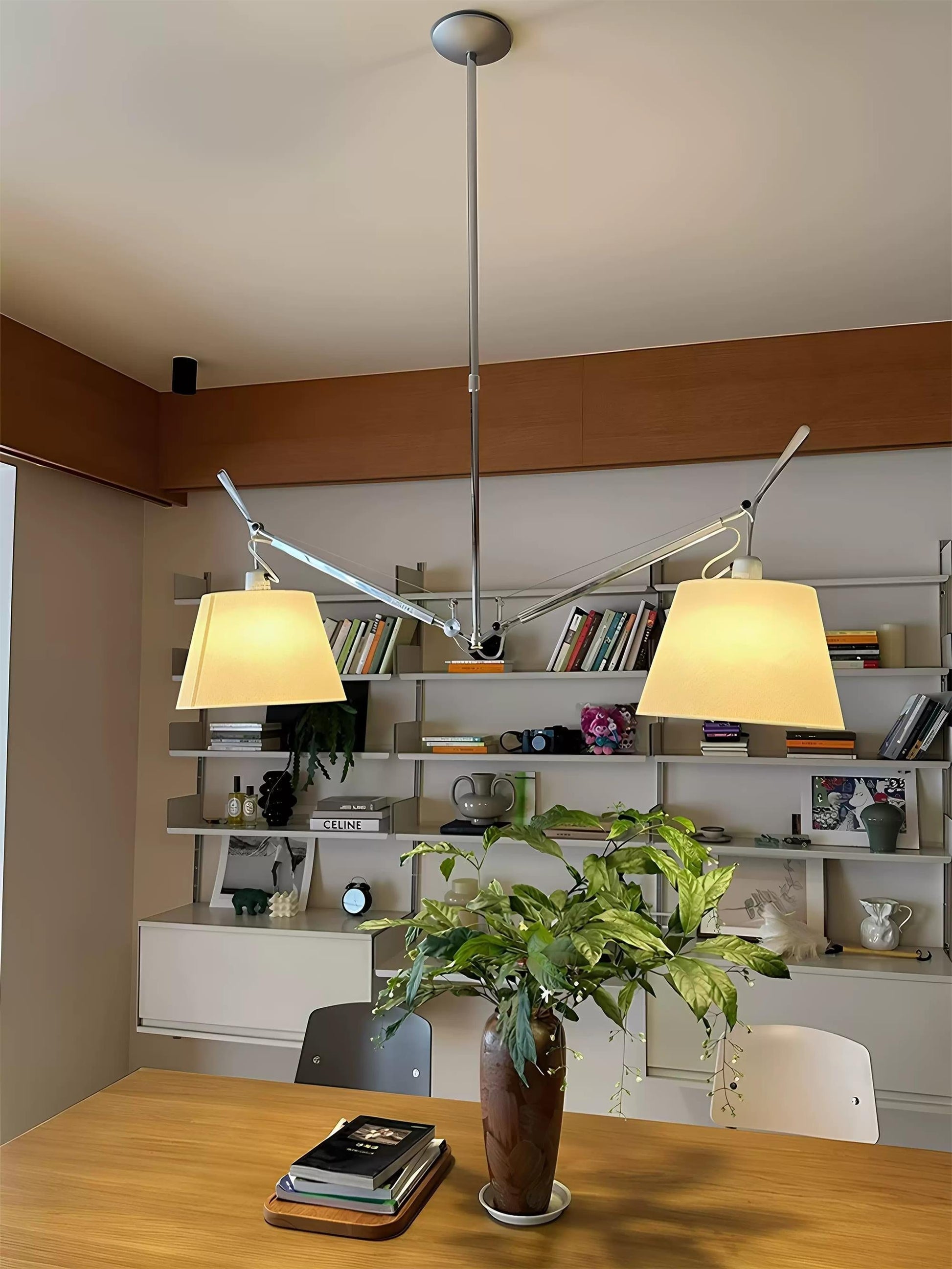 Adjusting the height of the Costanza Pendant Lamp using its arm system.