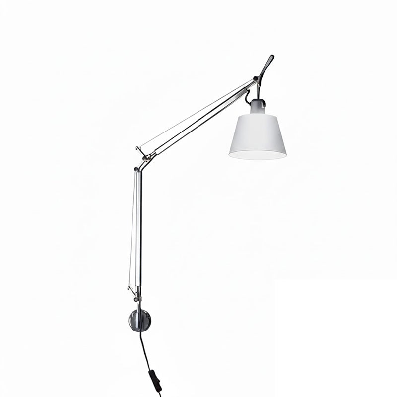 Lifestyle image of the lamp in a home office setting illuminating a desk.