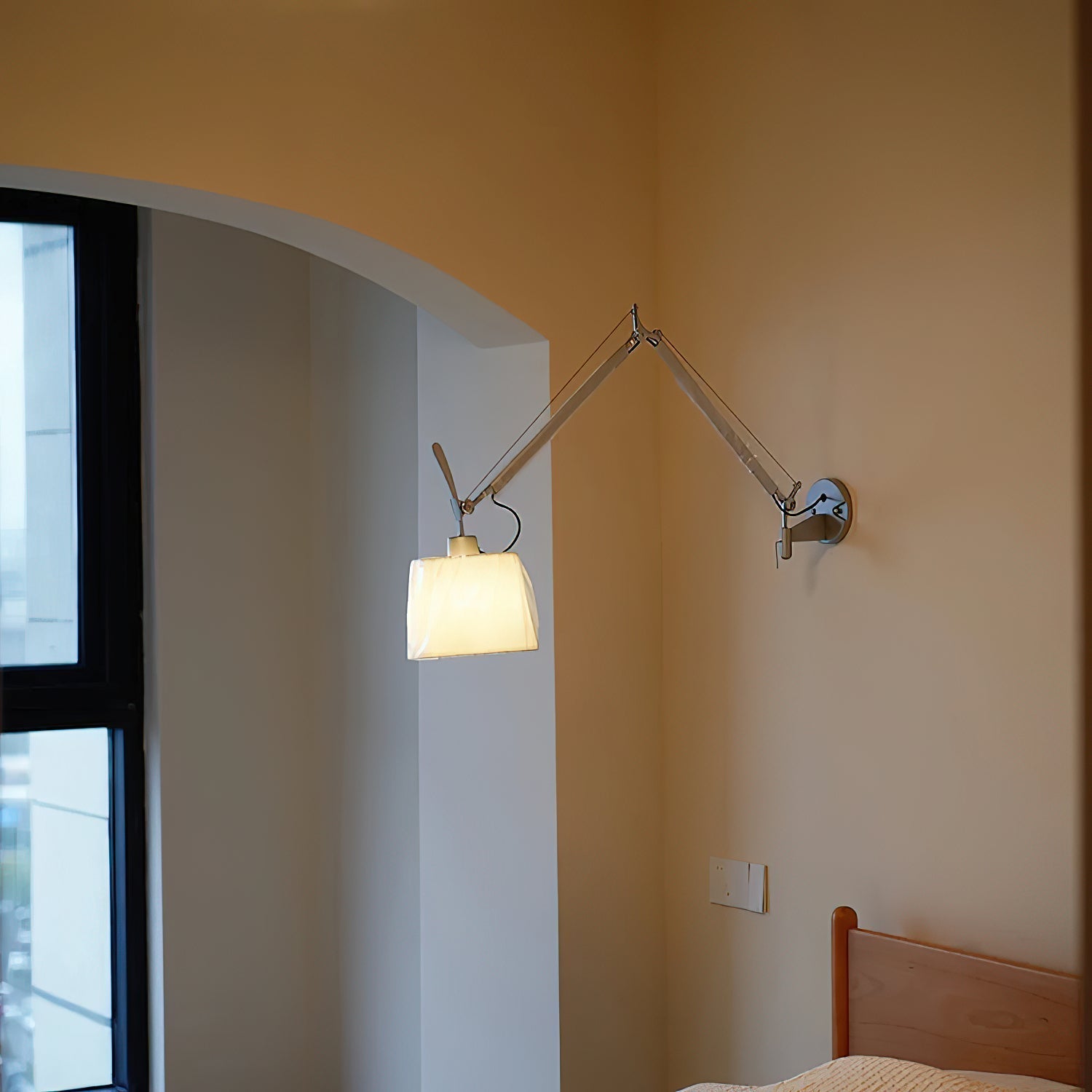 The yellow version of the Costanza swing-arm lamp adding a pop of color to a room.