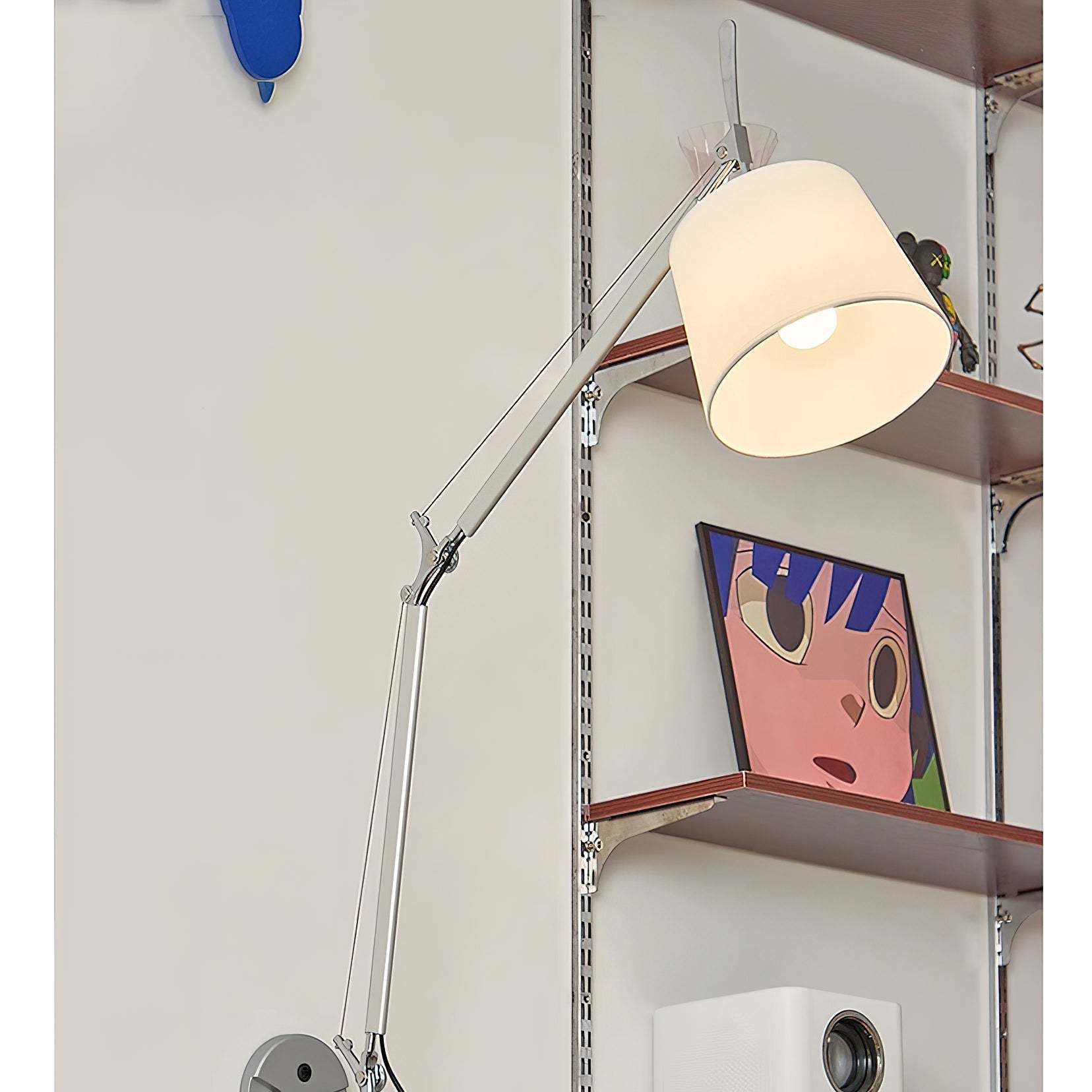 Costanza lamp mounted beside a bed, providing reading light.