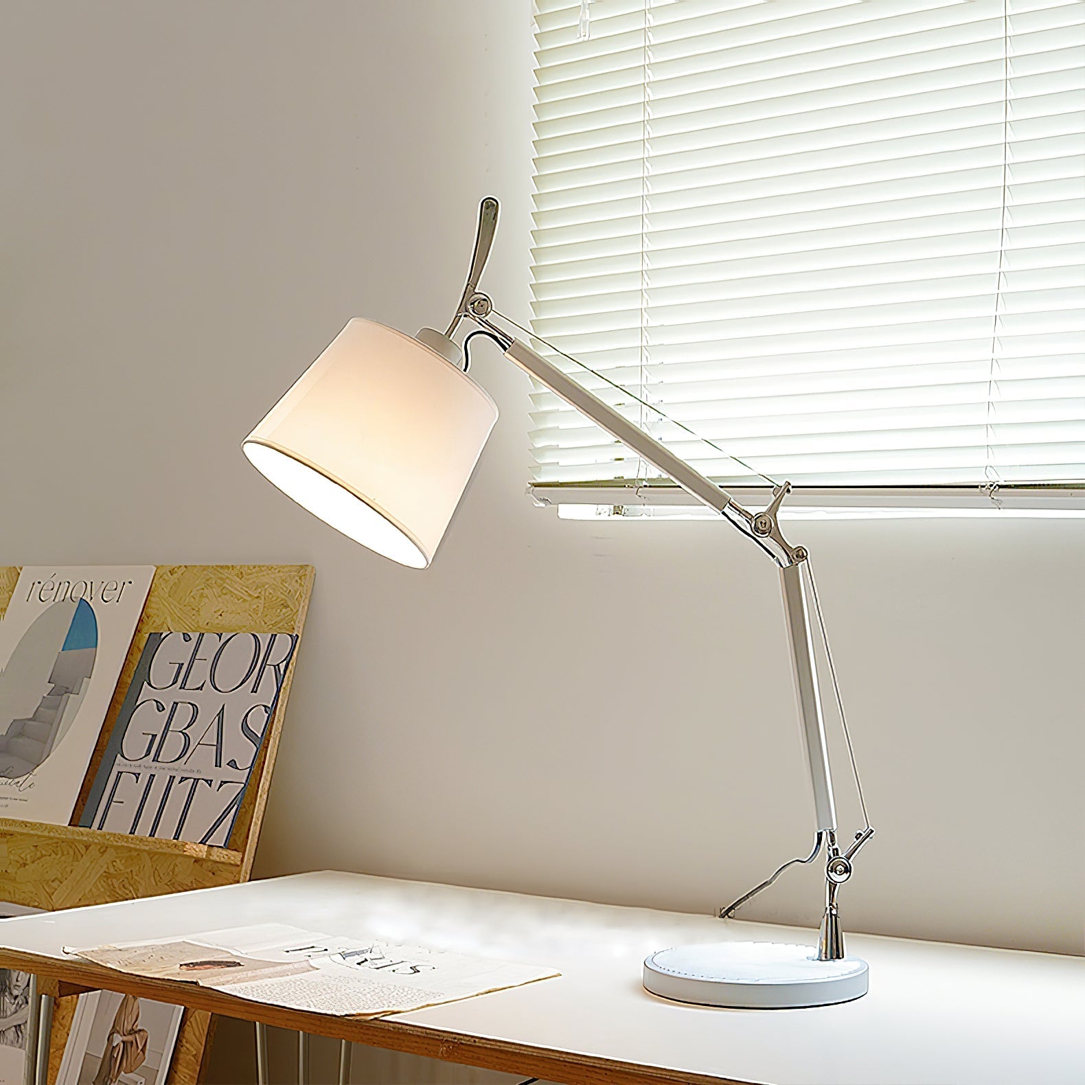 Detail shot of the lamp's slender aluminum stem and base.