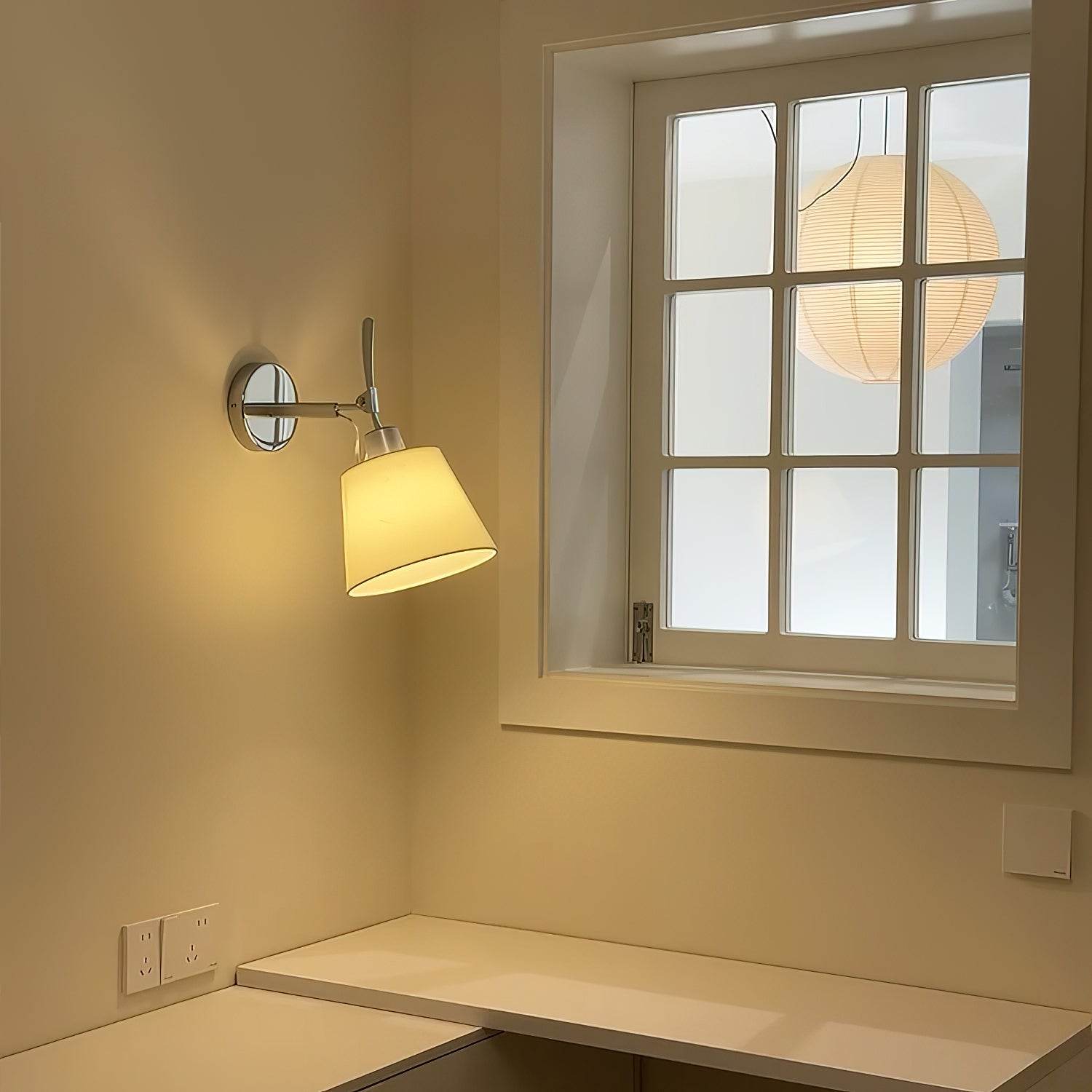 Close-up of the fabric drum shade on the Costanza wall lamp.