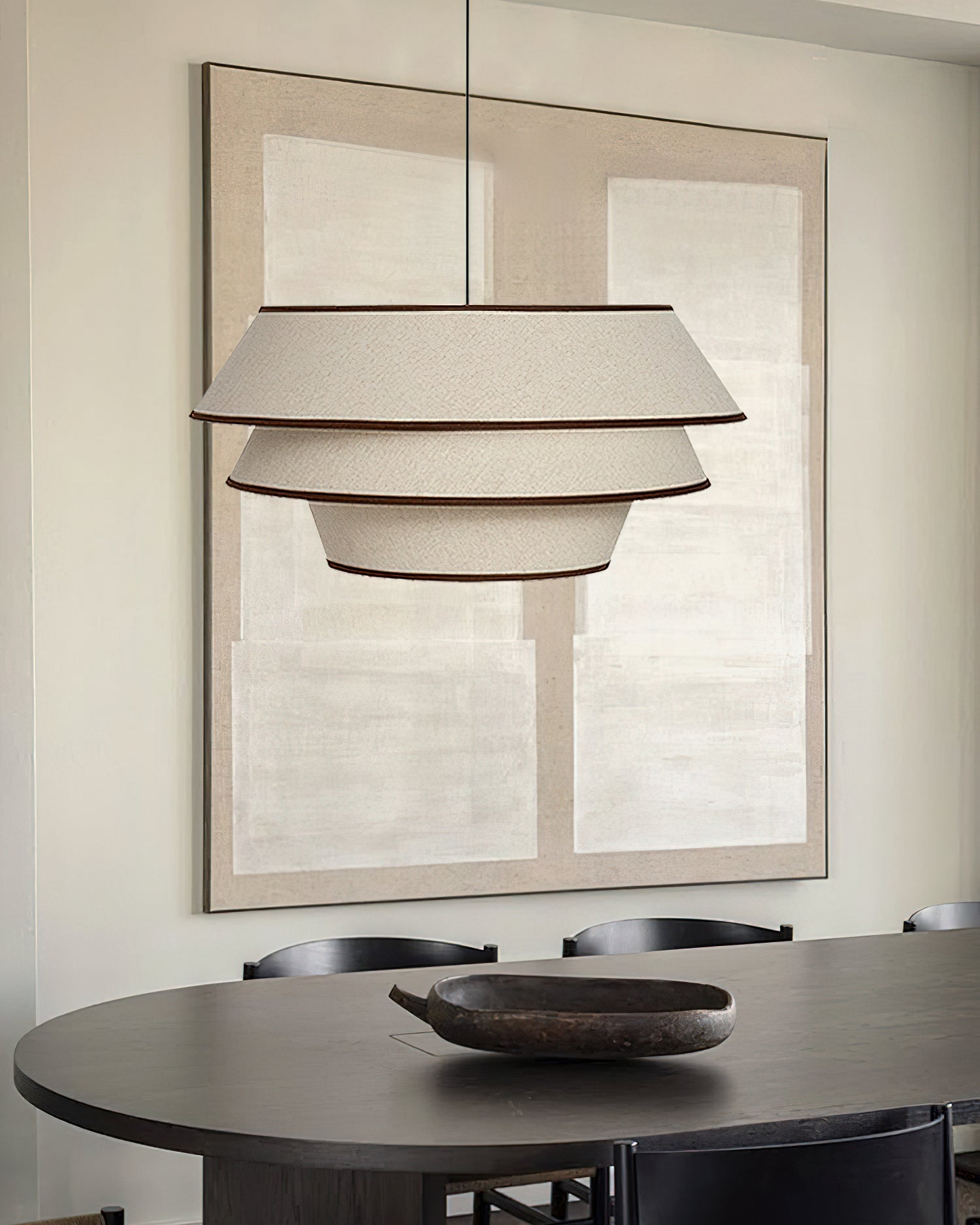 A pair of Auden Pendant Lights hanging over a long kitchen island.