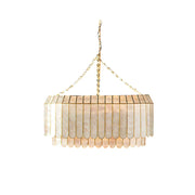 Aurelia Capiz Pendant Lamp with two tiers of shells, shown in a living room setting.
