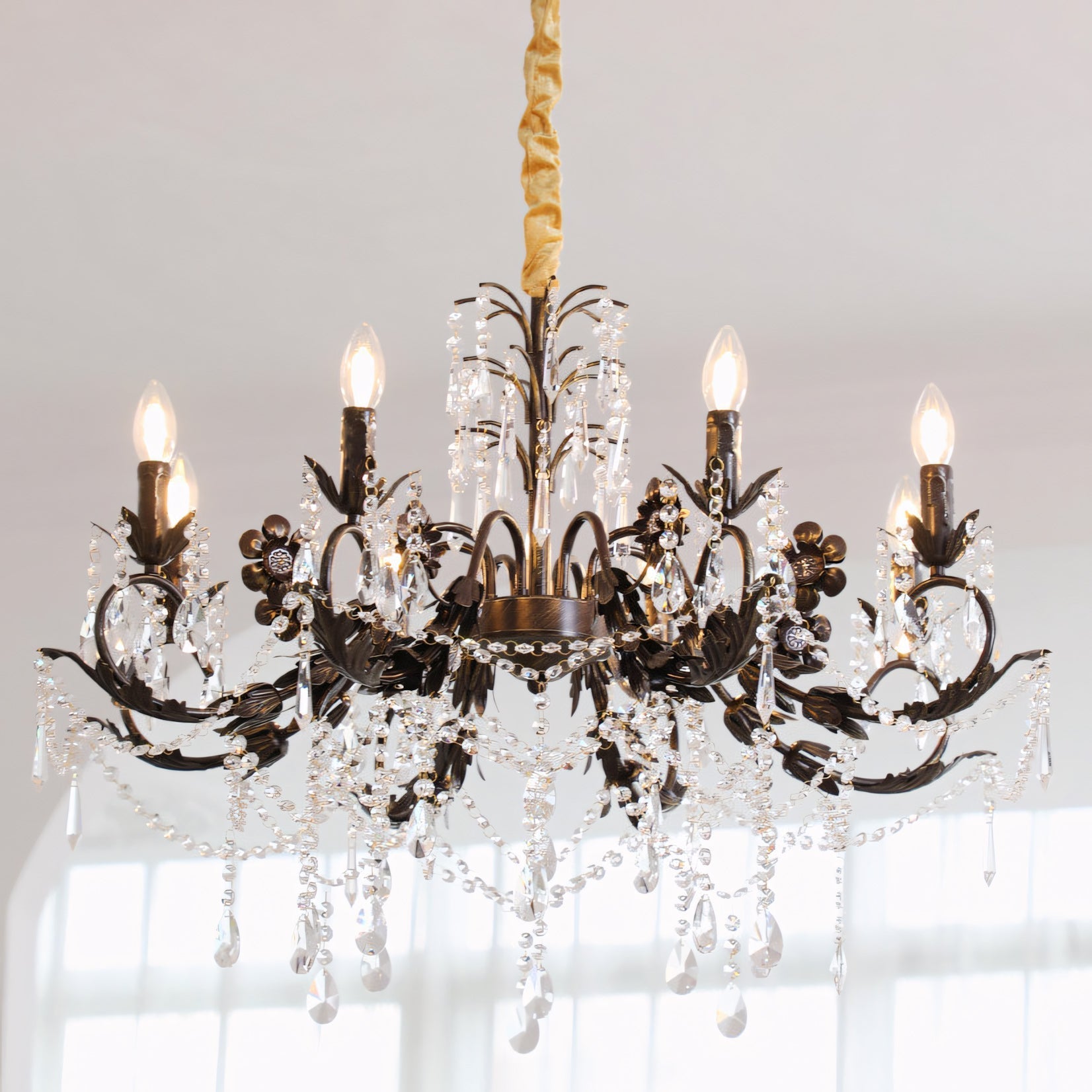 The chandelier hanging over a formal dining table.