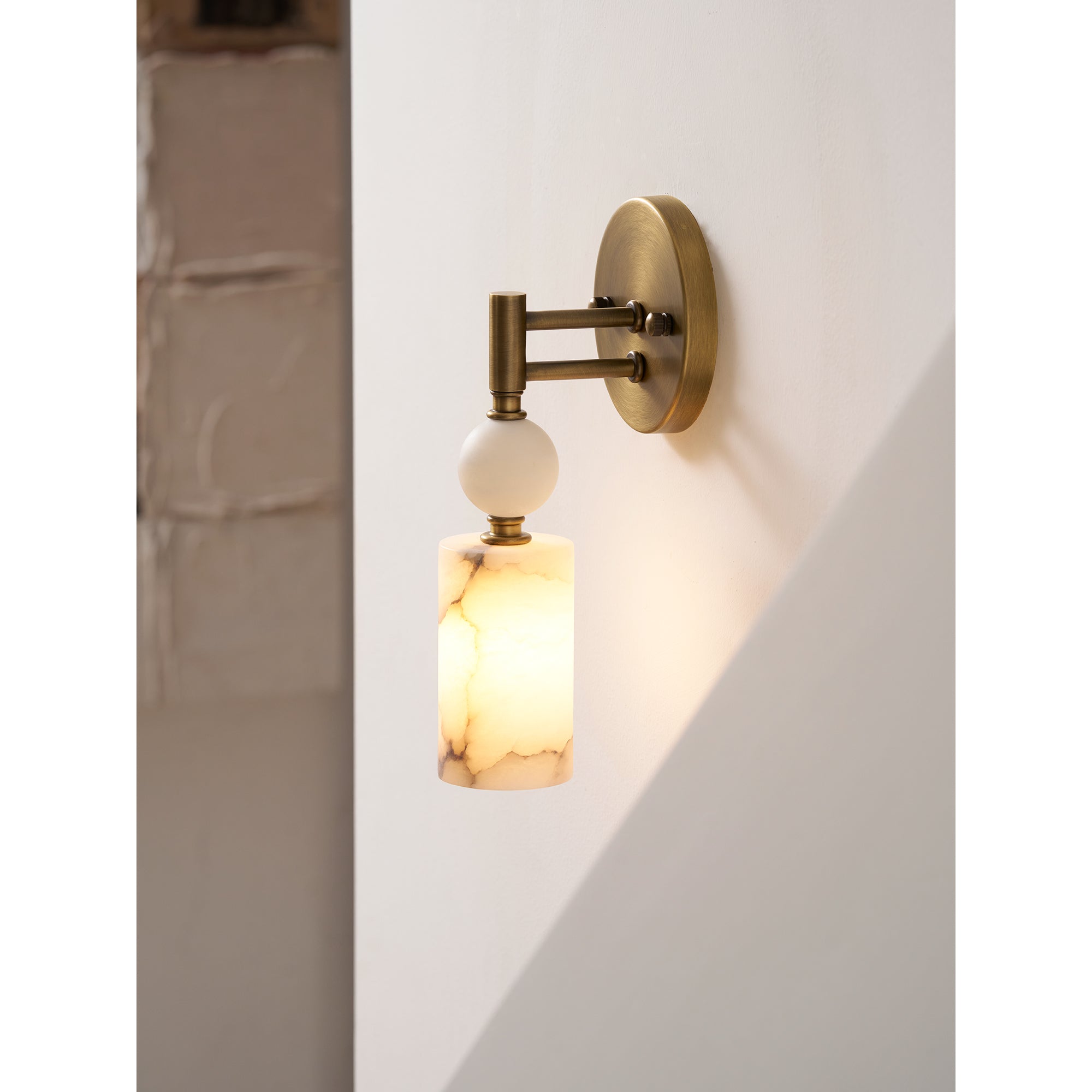 The Kingston Marble Wall Lamp installed in a sophisticated hallway setting.