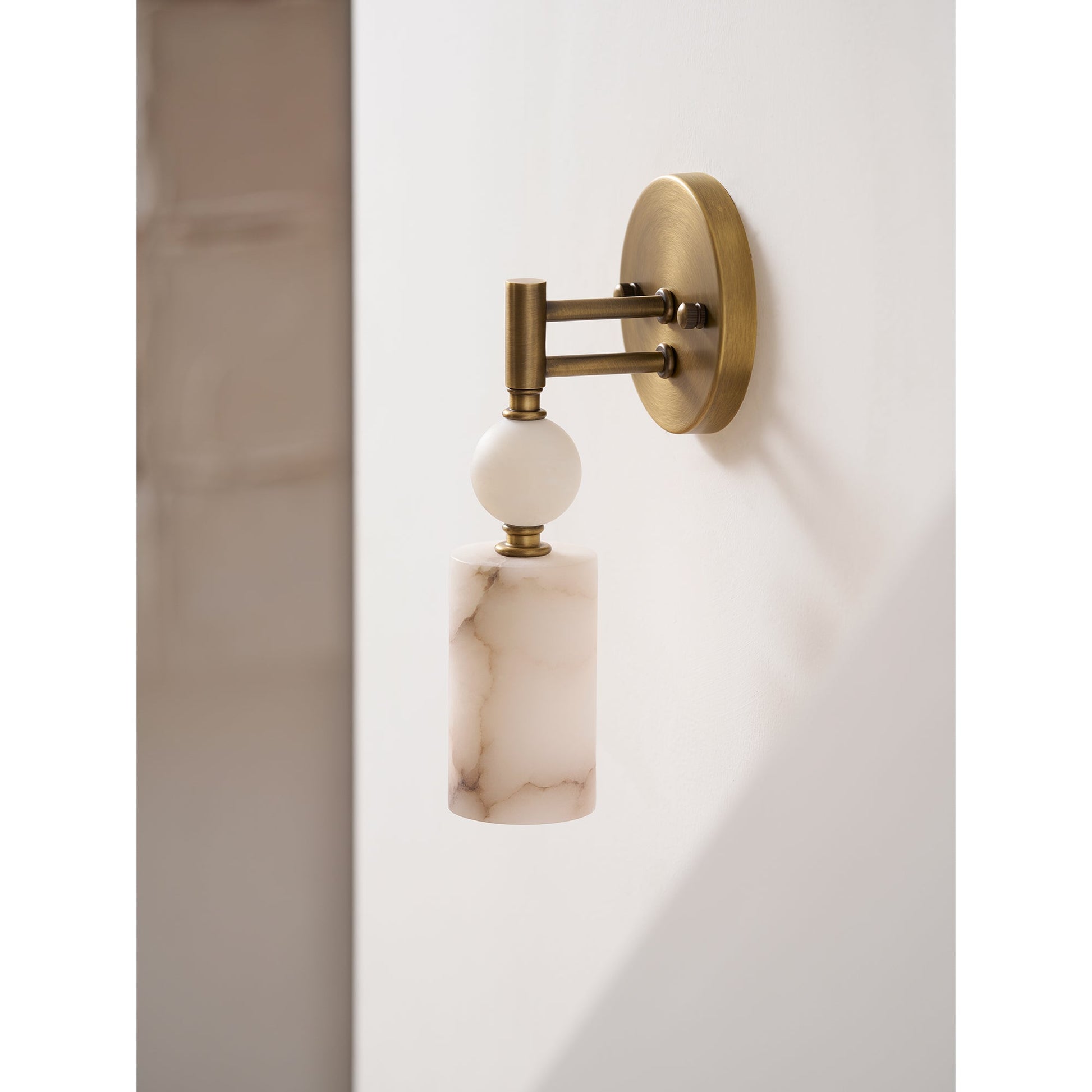 Angled shot highlighting the contrast between the brass and marble materials.