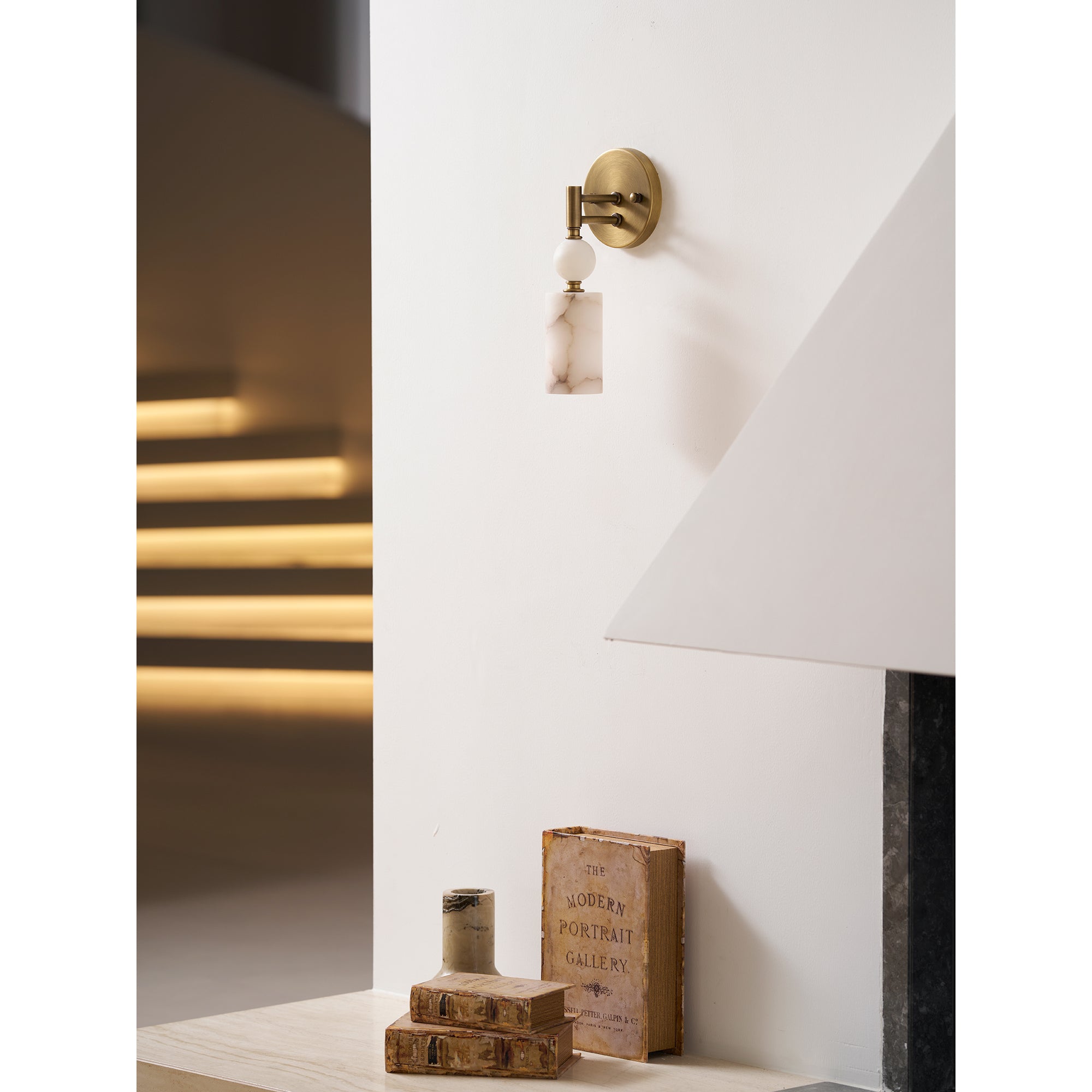 Lifestyle view of the Kingston Marble Wall Lamp in a modern living room.