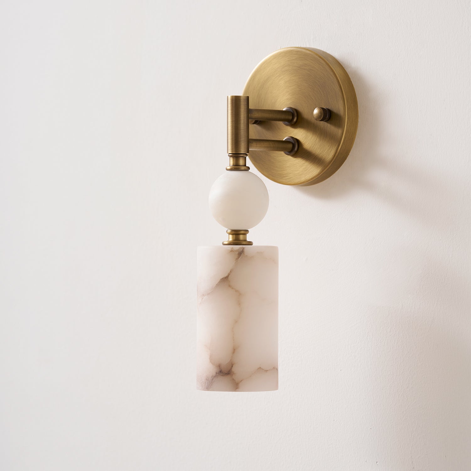 Detail shot of the warm, antique brass finish on the lamp's fixture.
