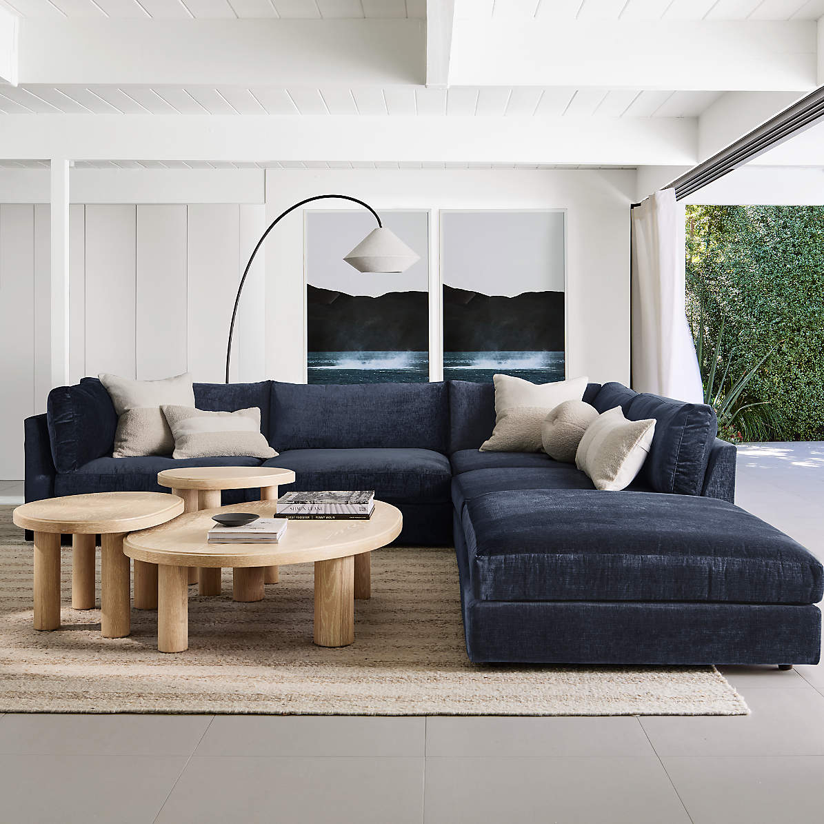 The white Avenir Arc Floor Lamp against a neutral wall.