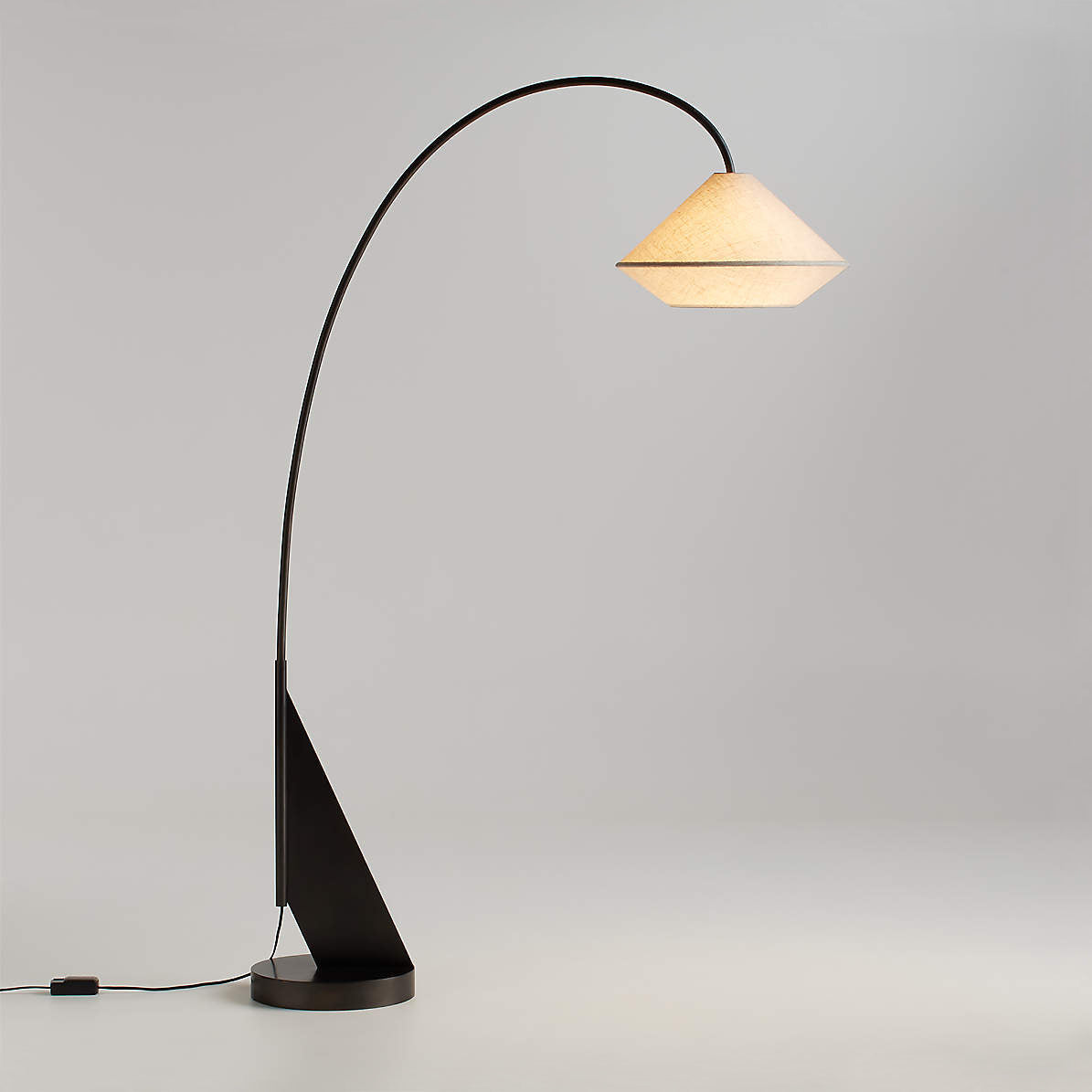 Avenir Arc Floor Lamp providing ambient light over a sofa.