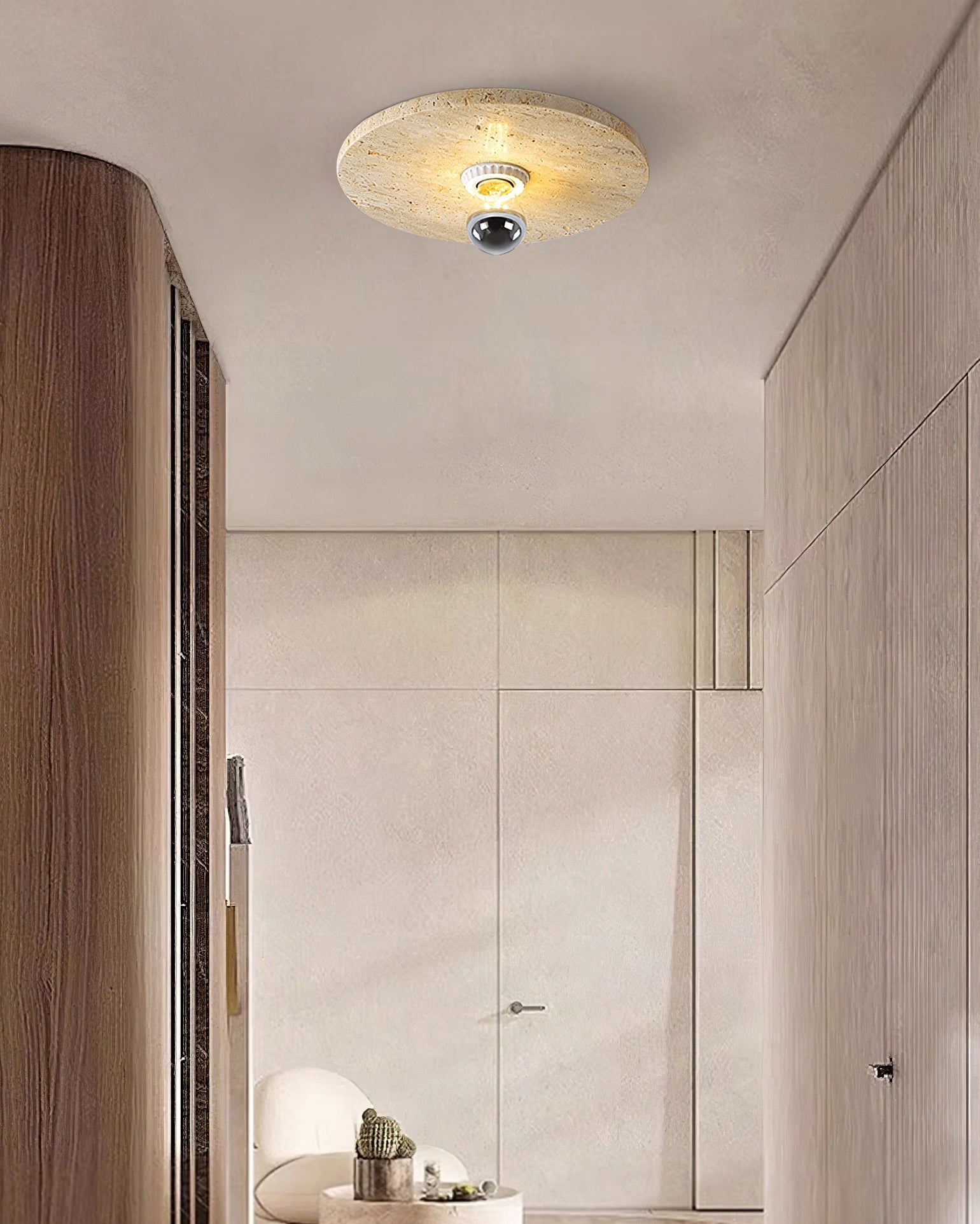 The lamp illuminated, highlighting the translucency of the travertine.