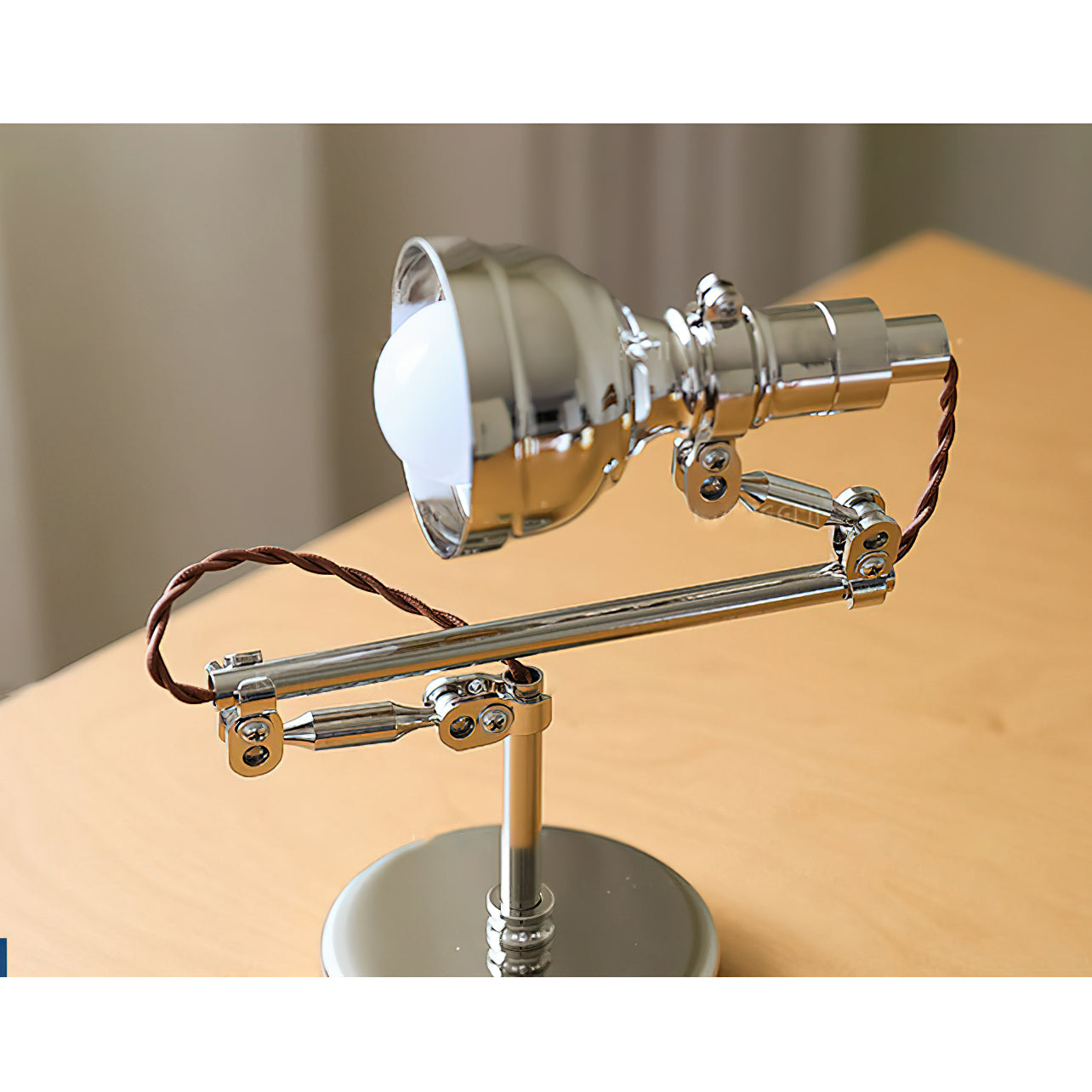 The wall lamp retracted against the wall to save space.