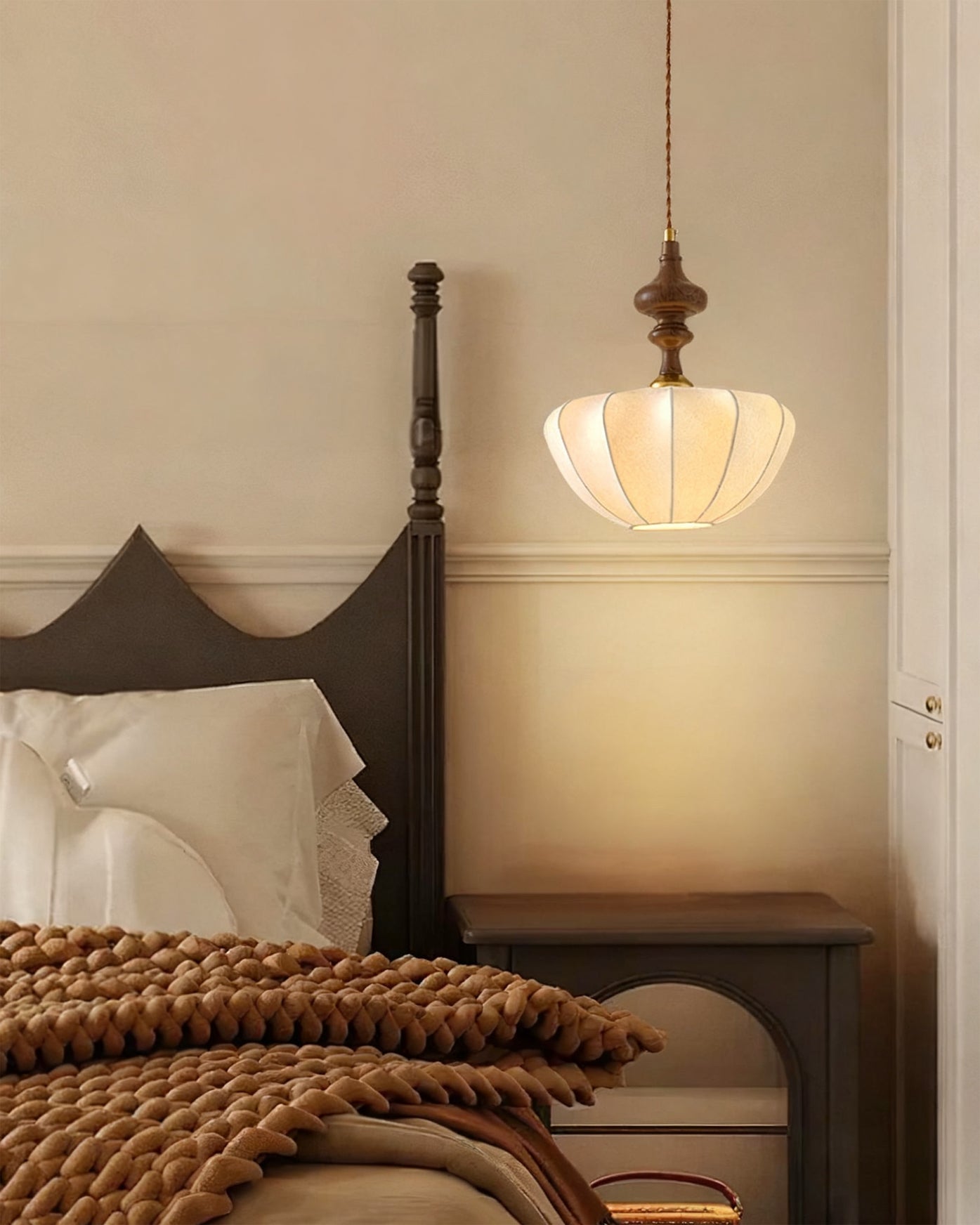 Detail shot of the carved wood-toned top piece of the pendant light.