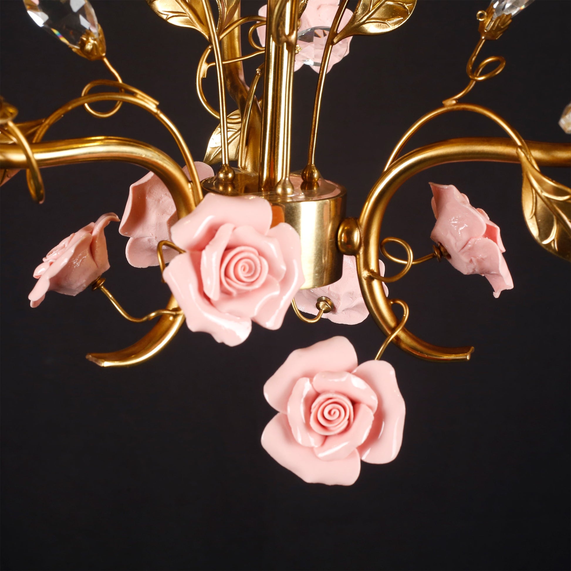 Close-up on a candle-style bulb and ceramic rose.