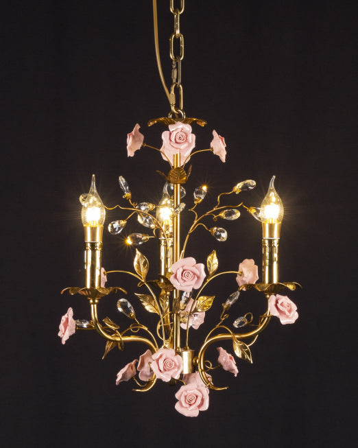 The chandelier in a bedroom setting above a bed.