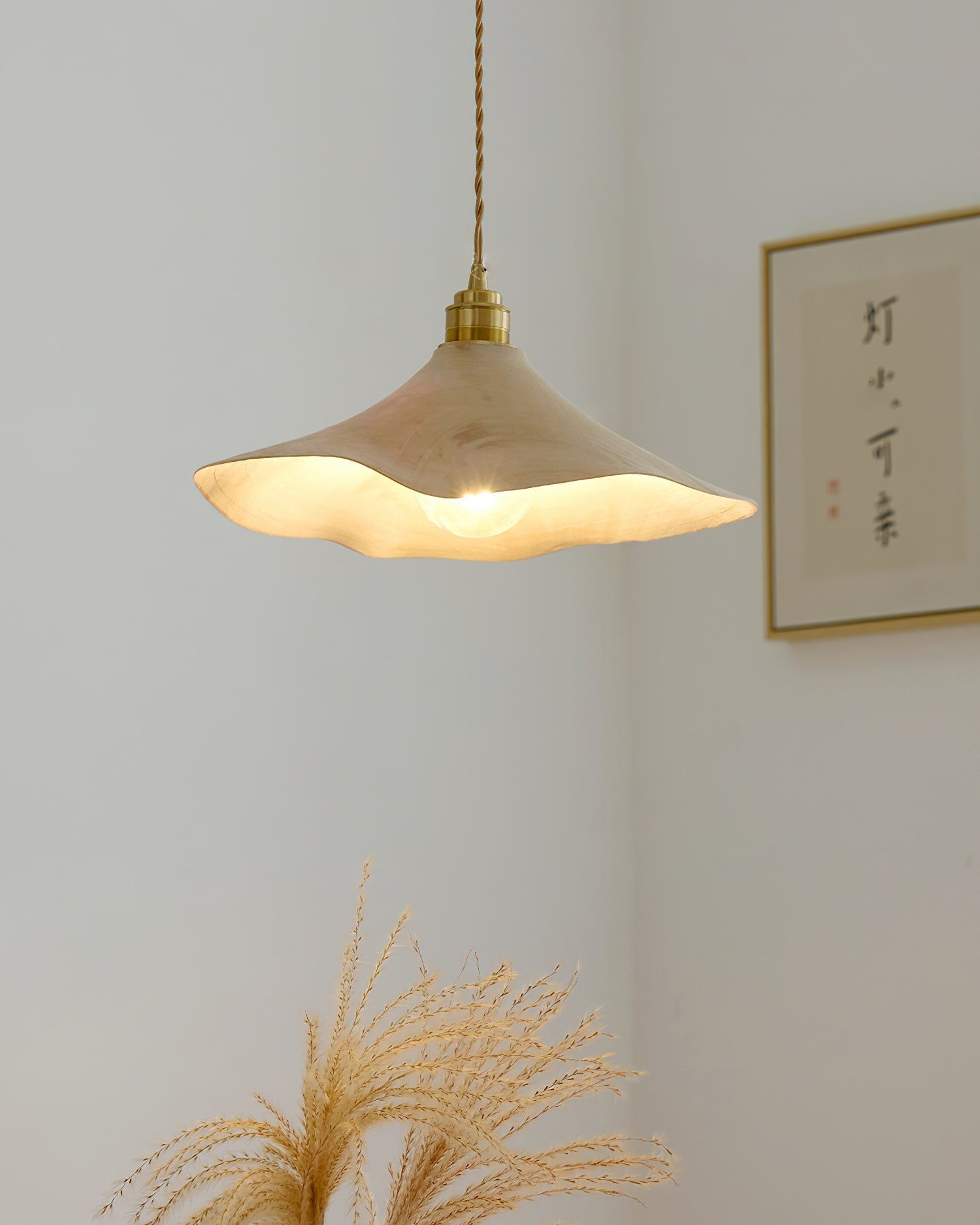 The Baxter Pendant Light shown illuminated, casting a warm ambient glow.