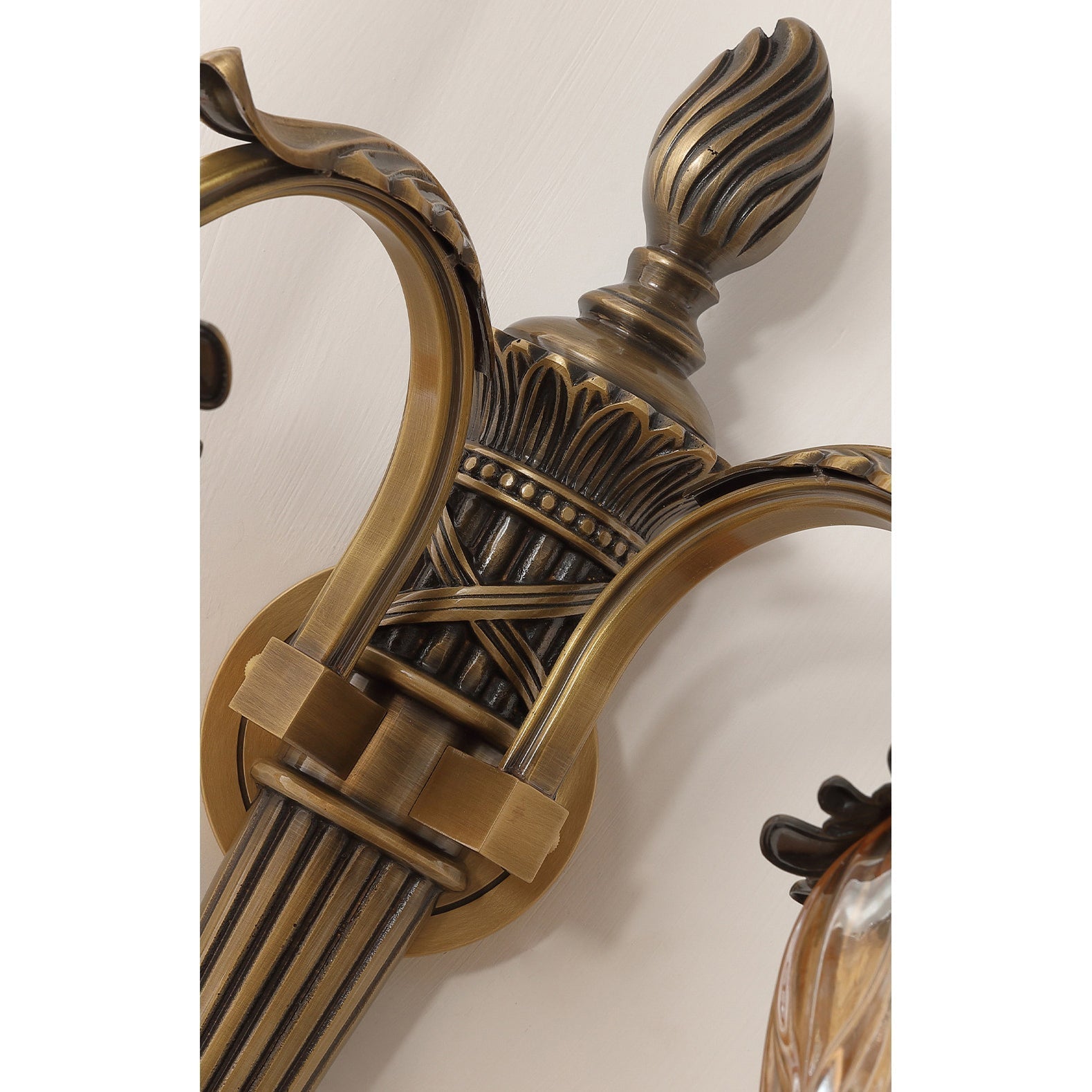 The top of the Benson Wall Lamp, showing the glass shade and brass fixture.