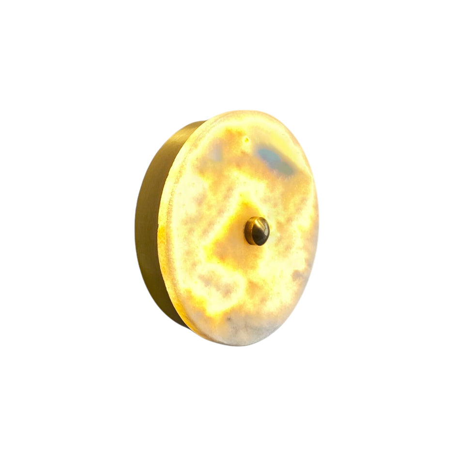 Beran Wall Lamp with a marble shade and copper body.