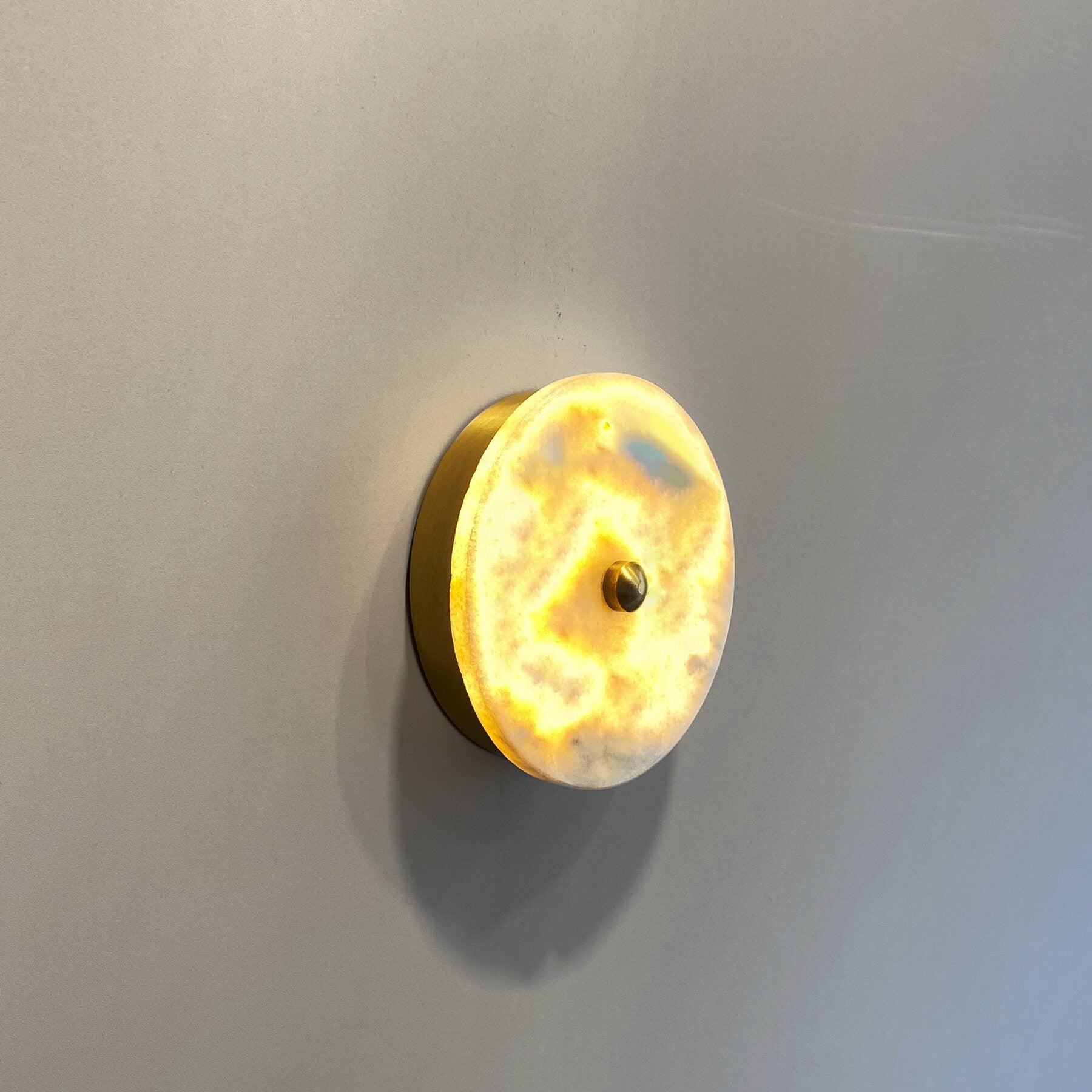 Close-up of the Beran Wall Lamp's natural marble pattern.