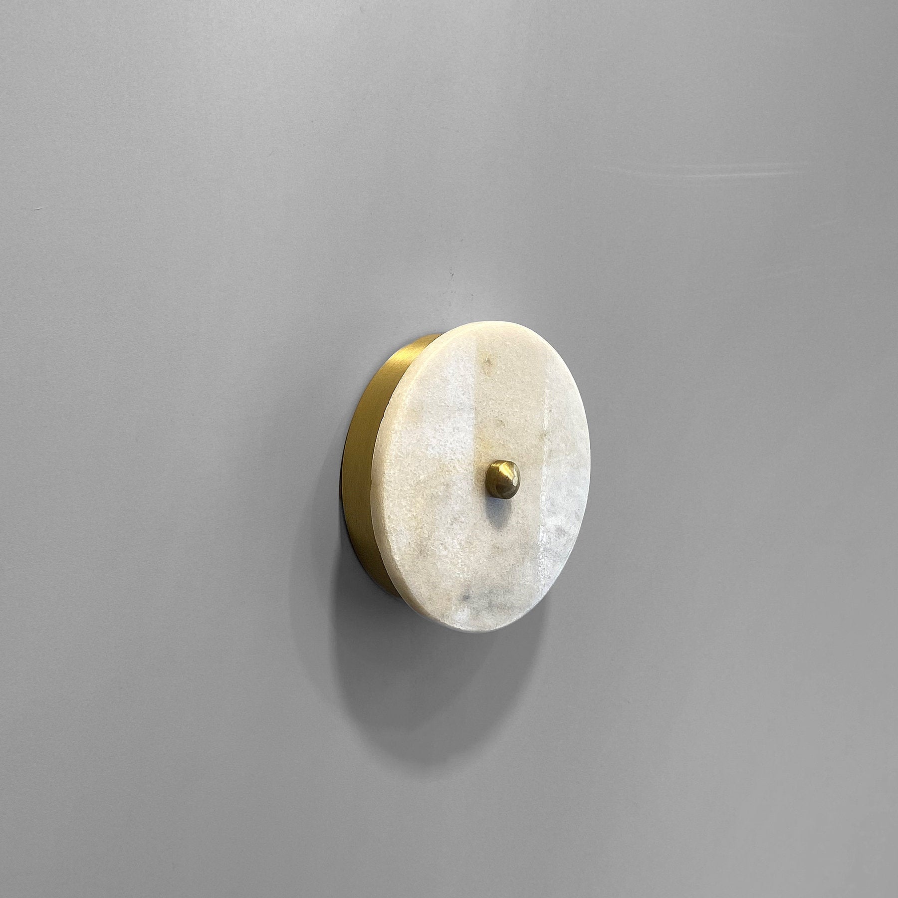 Angled view of the Beran Wall Lamp, highlighting its sleek metal construction.