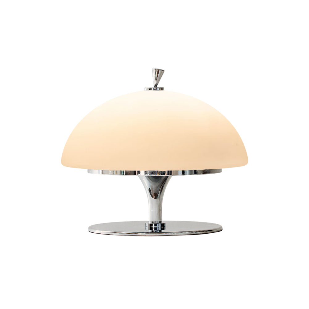 Beret Table Lamp in white with a chrome base, shown on a wooden surface.
