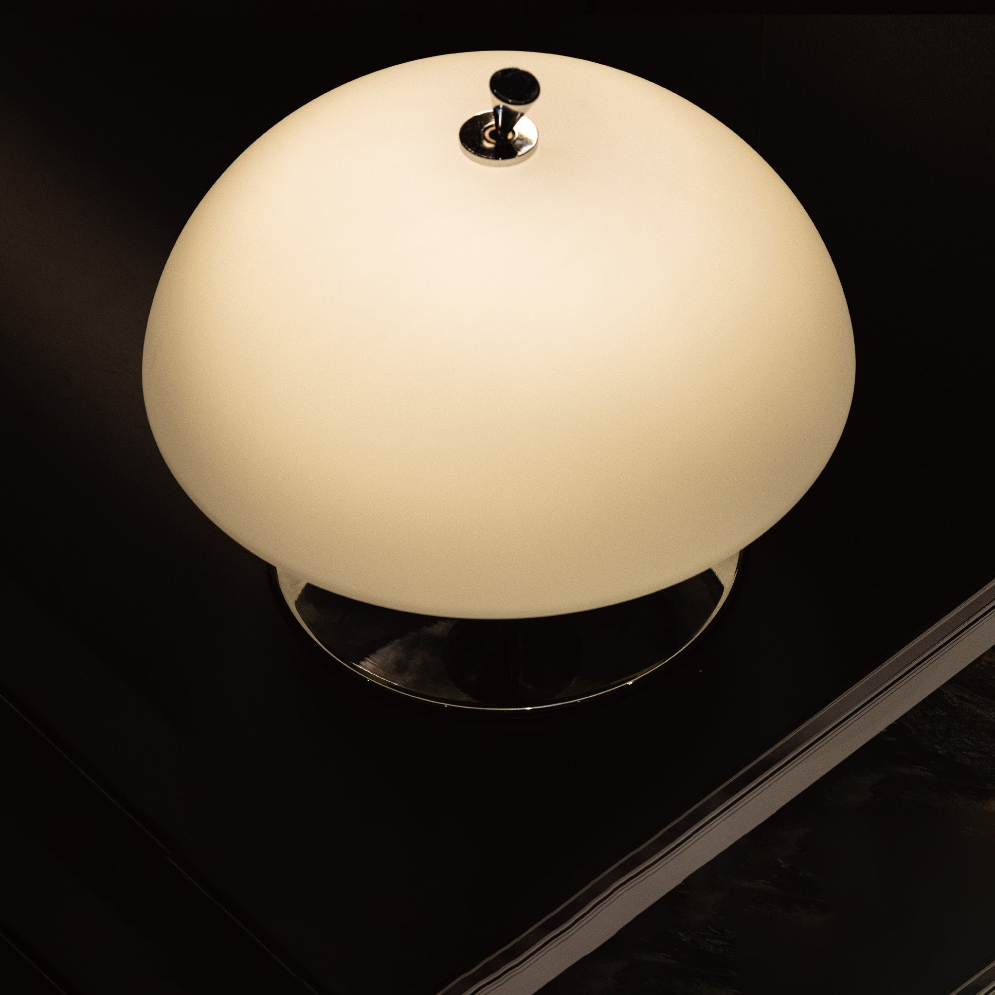 Angled view of the white and chrome Beret Table Lamp against a neutral background.