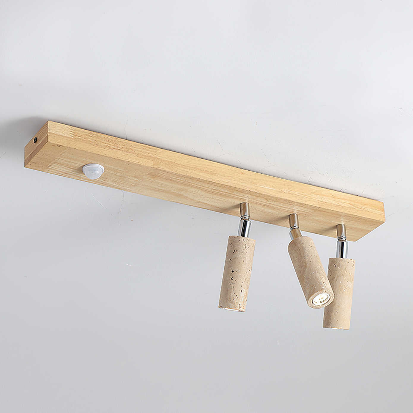 Close-up of an adjustable travertine spotlight on the Berge ceiling light.