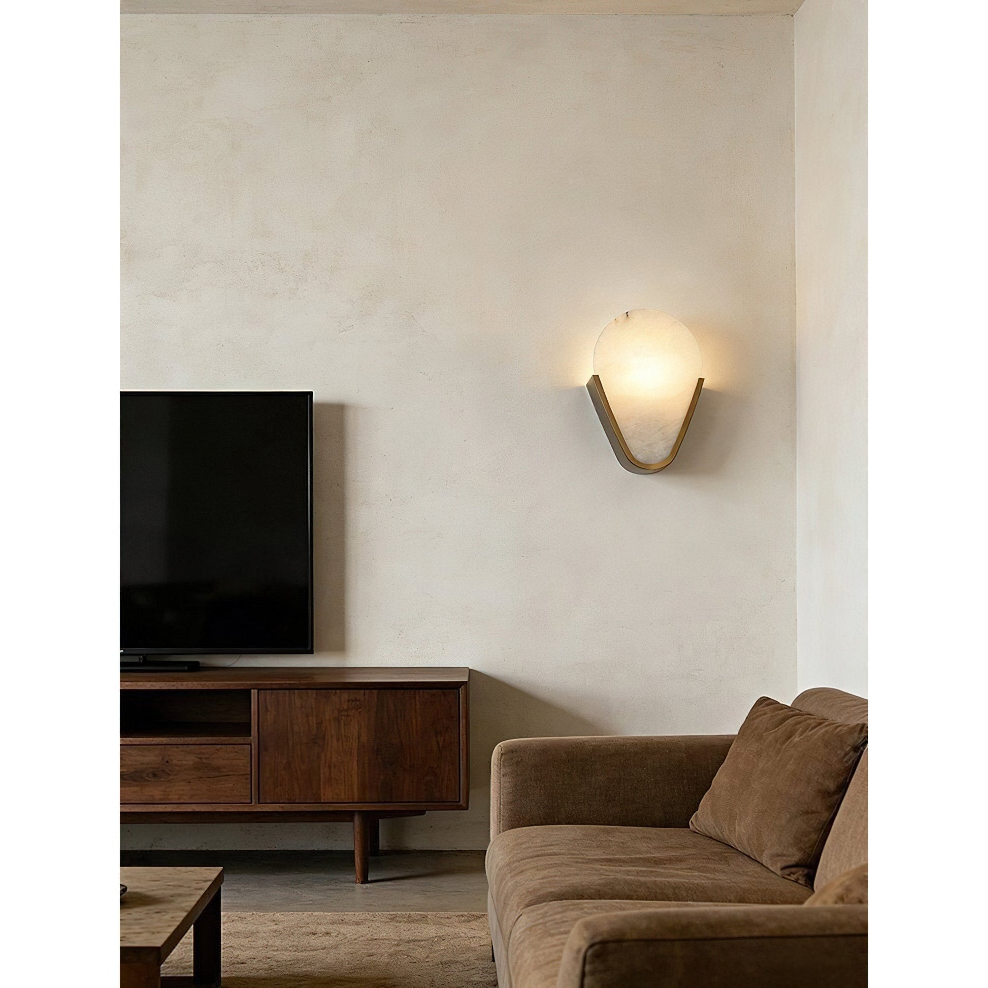 The wall lamp shown against a dark, textured wall for contrast.