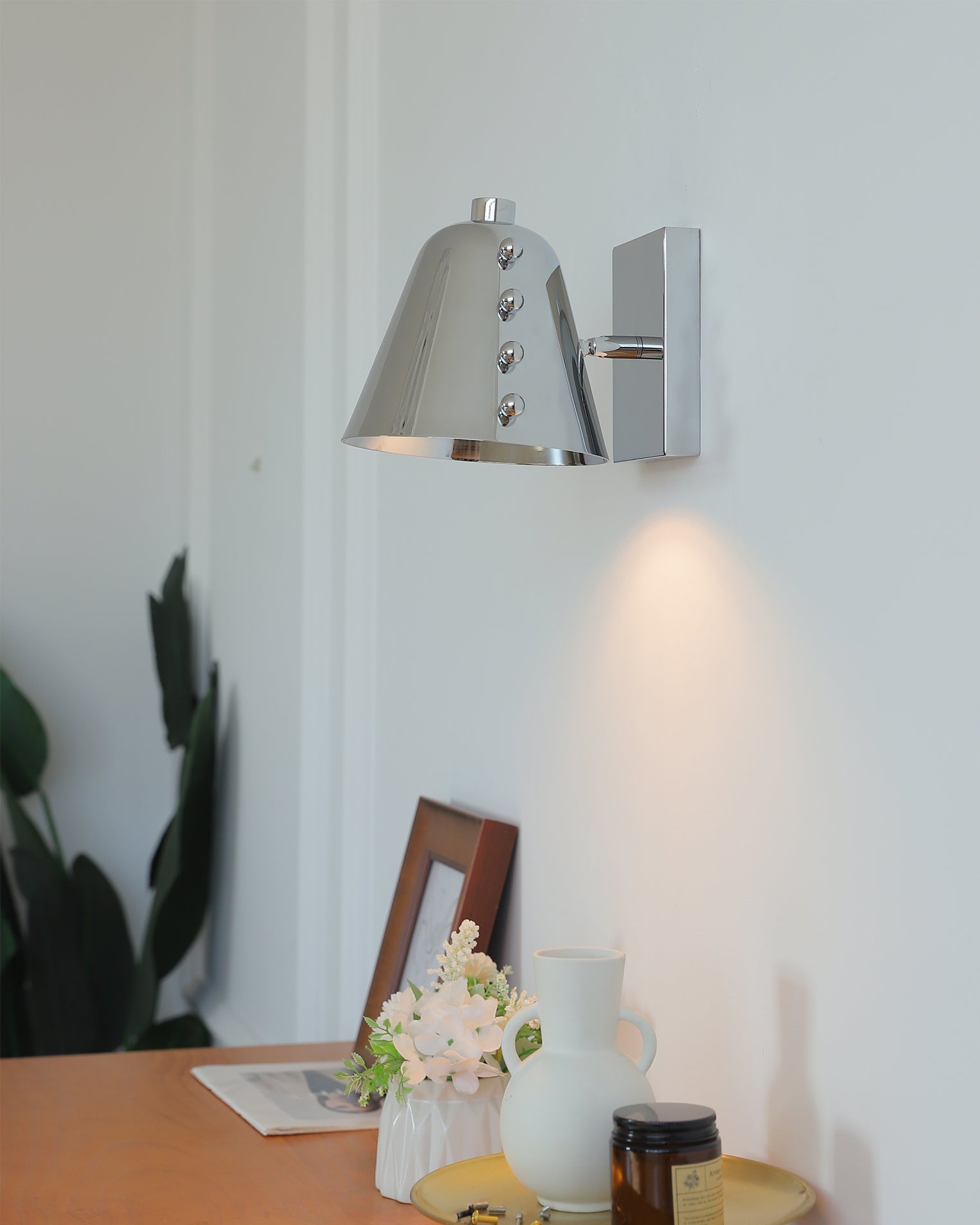 Bespoke wall lamp casting a warm glow in a lounge area.