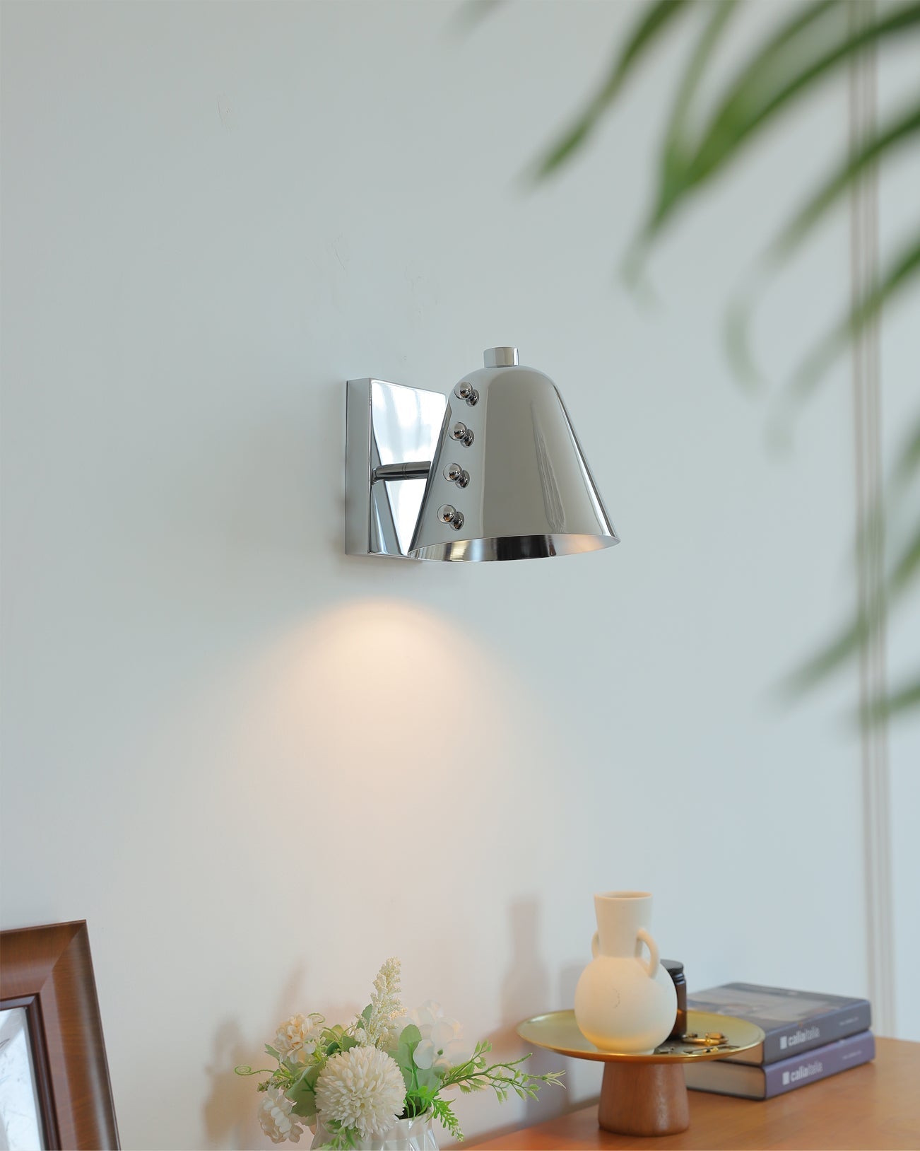 Bespoke wall lamp installed in a sophisticated entryway.