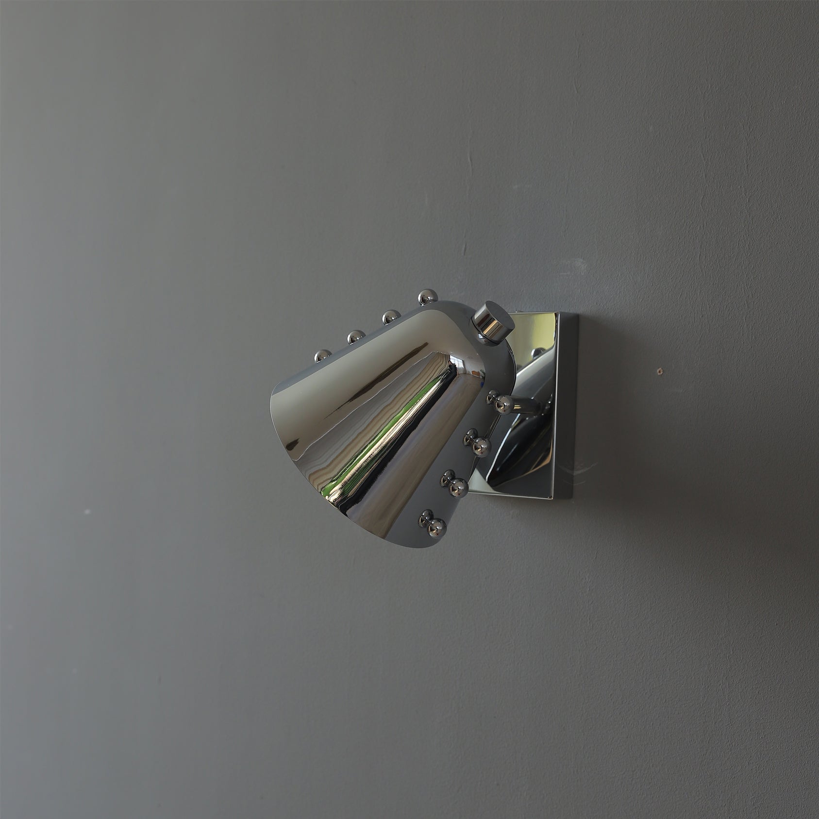 Bespoke wall lamp in a gold finish, unlit.