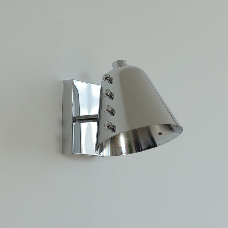 Bespoke wall lamp lit with an Edison bulb.