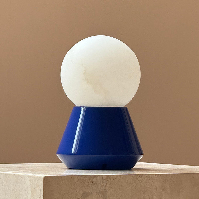 The white Bilia Mini Table Lamp against a light, neutral background.