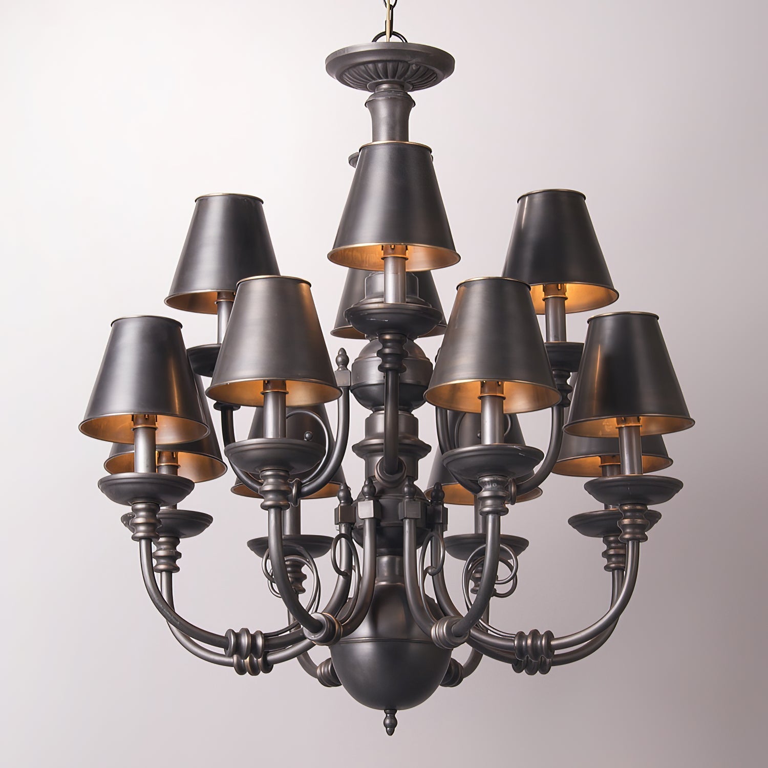 Close-up view of the Blanche Chandelier's black diffusers and brass details.