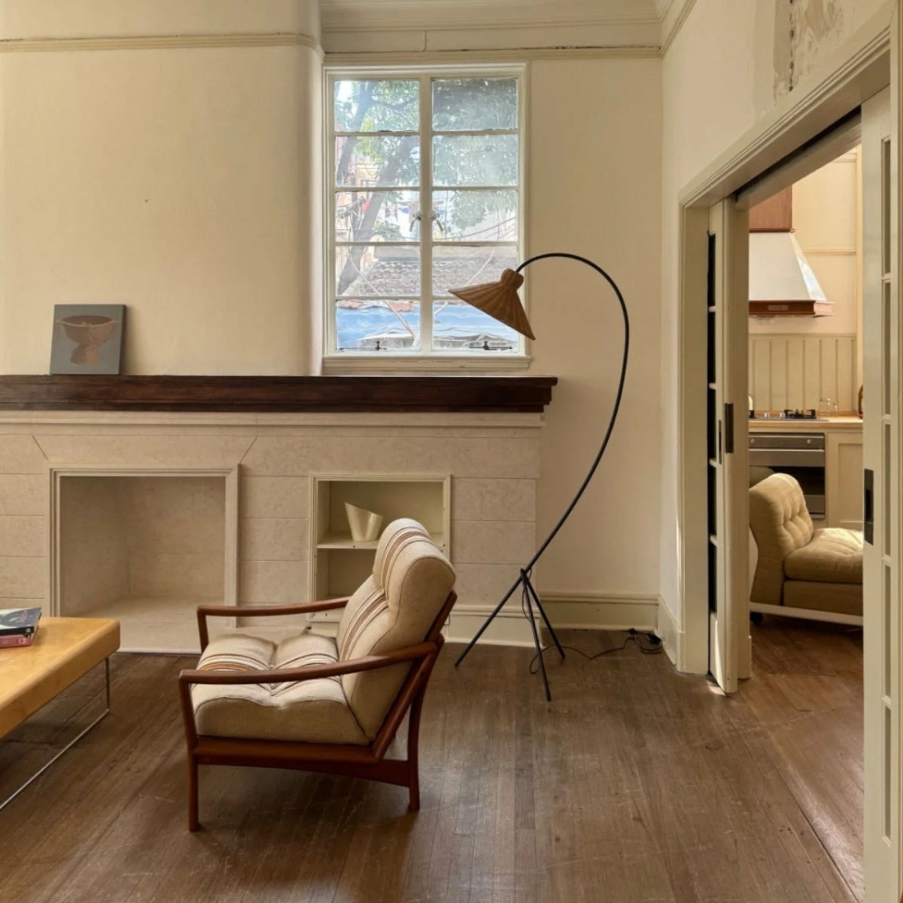 Boa Rattan Floor Lamp against a neutral wall.