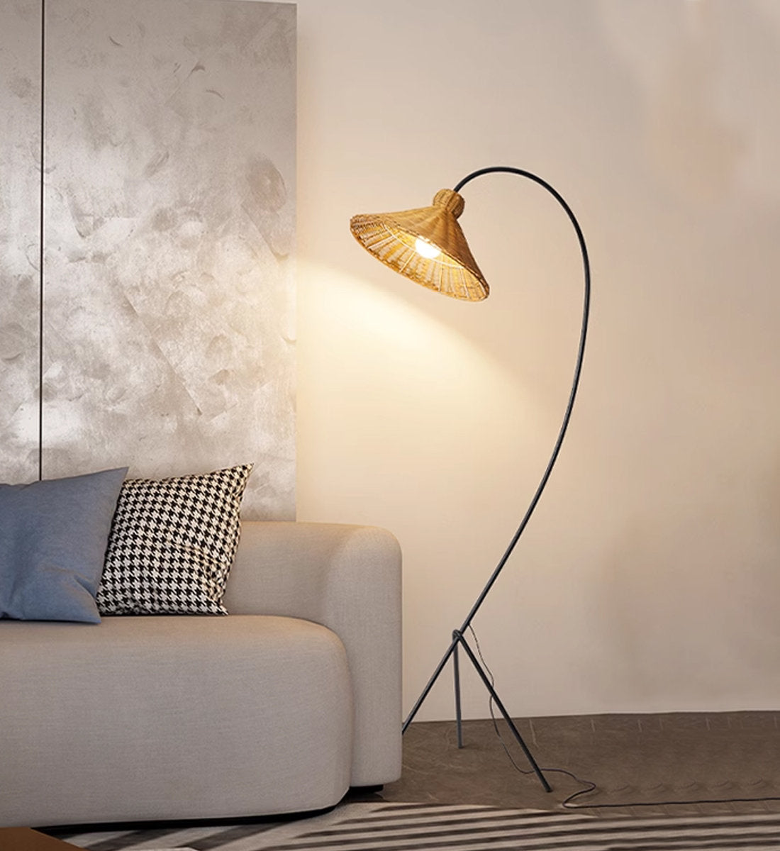 The elegant curve of the floor lamp's metal stand.
