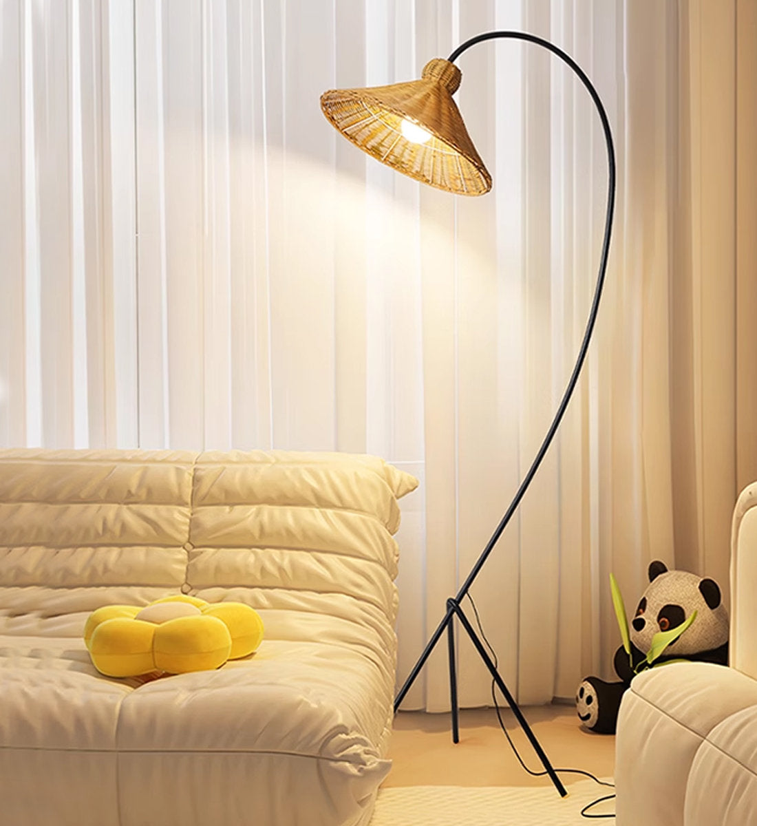 The Boa Rattan Floor Lamp shown in a modern living room setting.