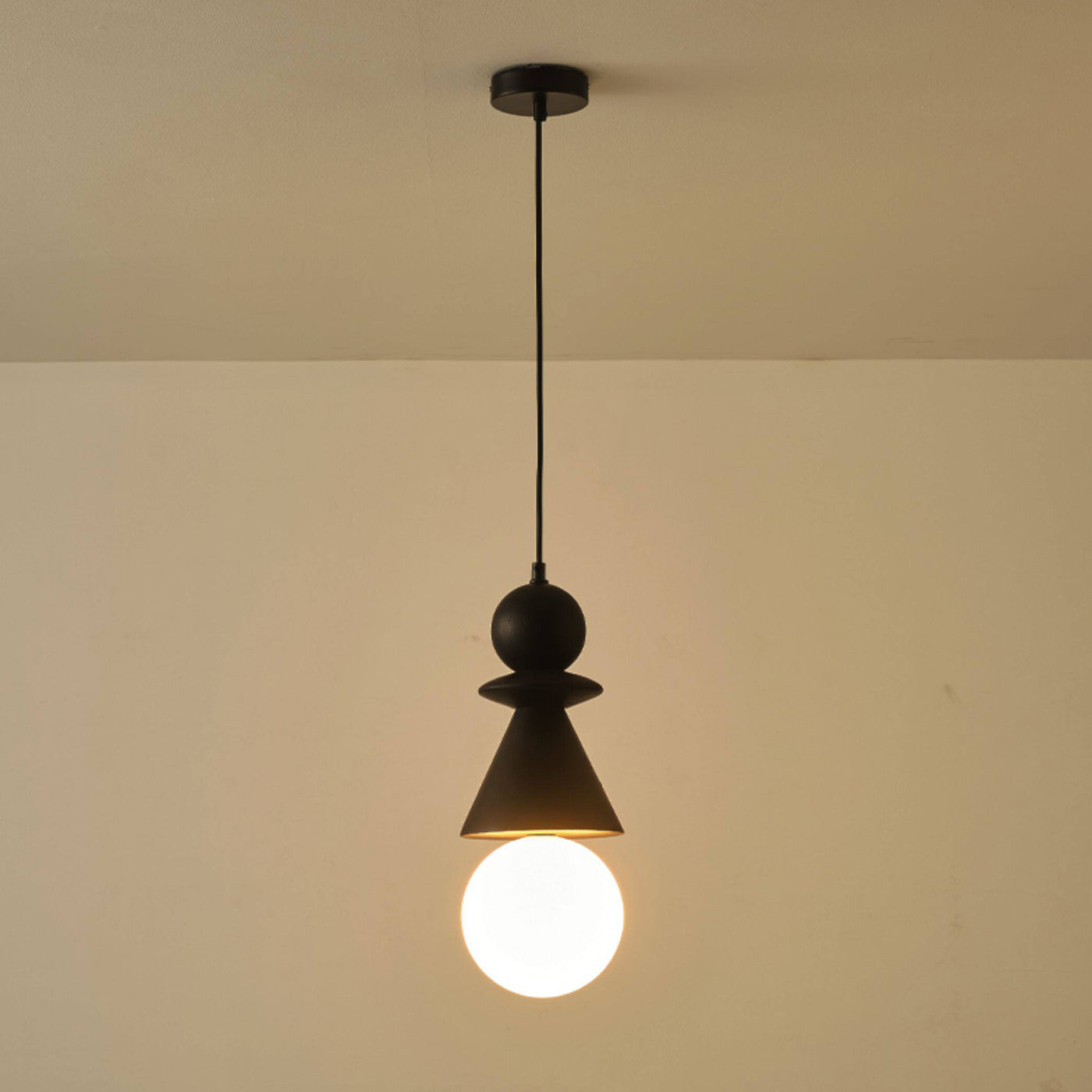 A pair of Bodie wood pendant lights hanging over a modern kitchen island.
