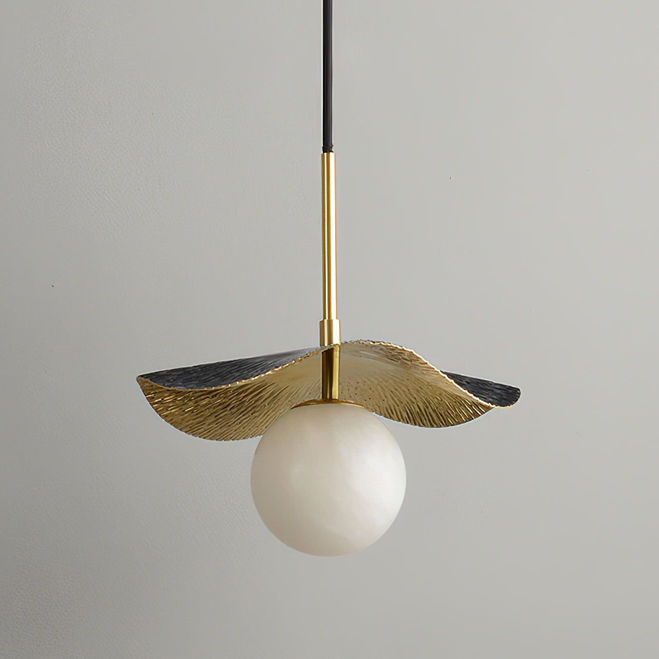 Detail shot of the hand-textured brass canopy of the Bonnie Pendant Lamp.