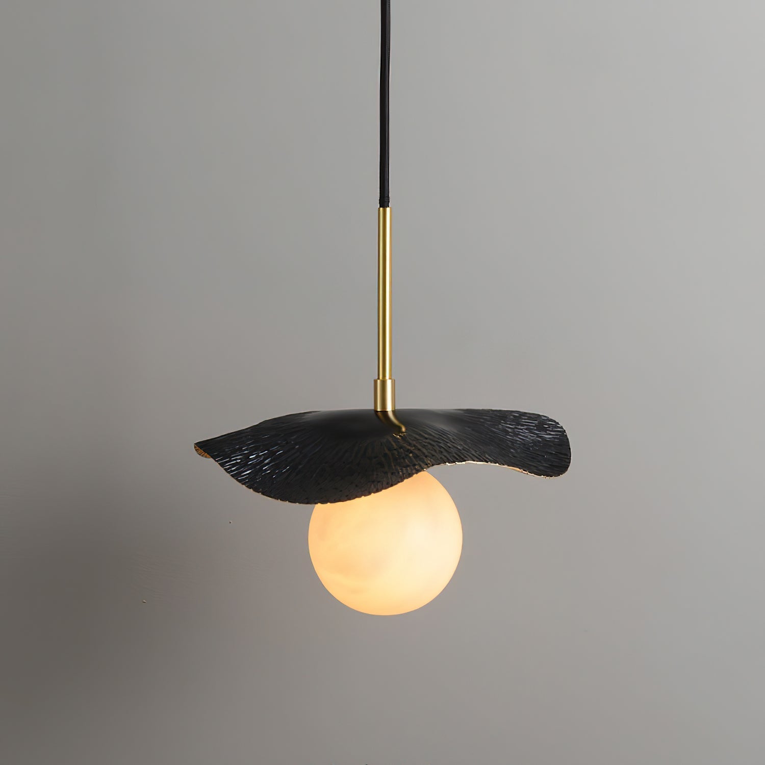Illuminated Bonnie Alabaster Pendant Lamp casting a warm, diffused light.